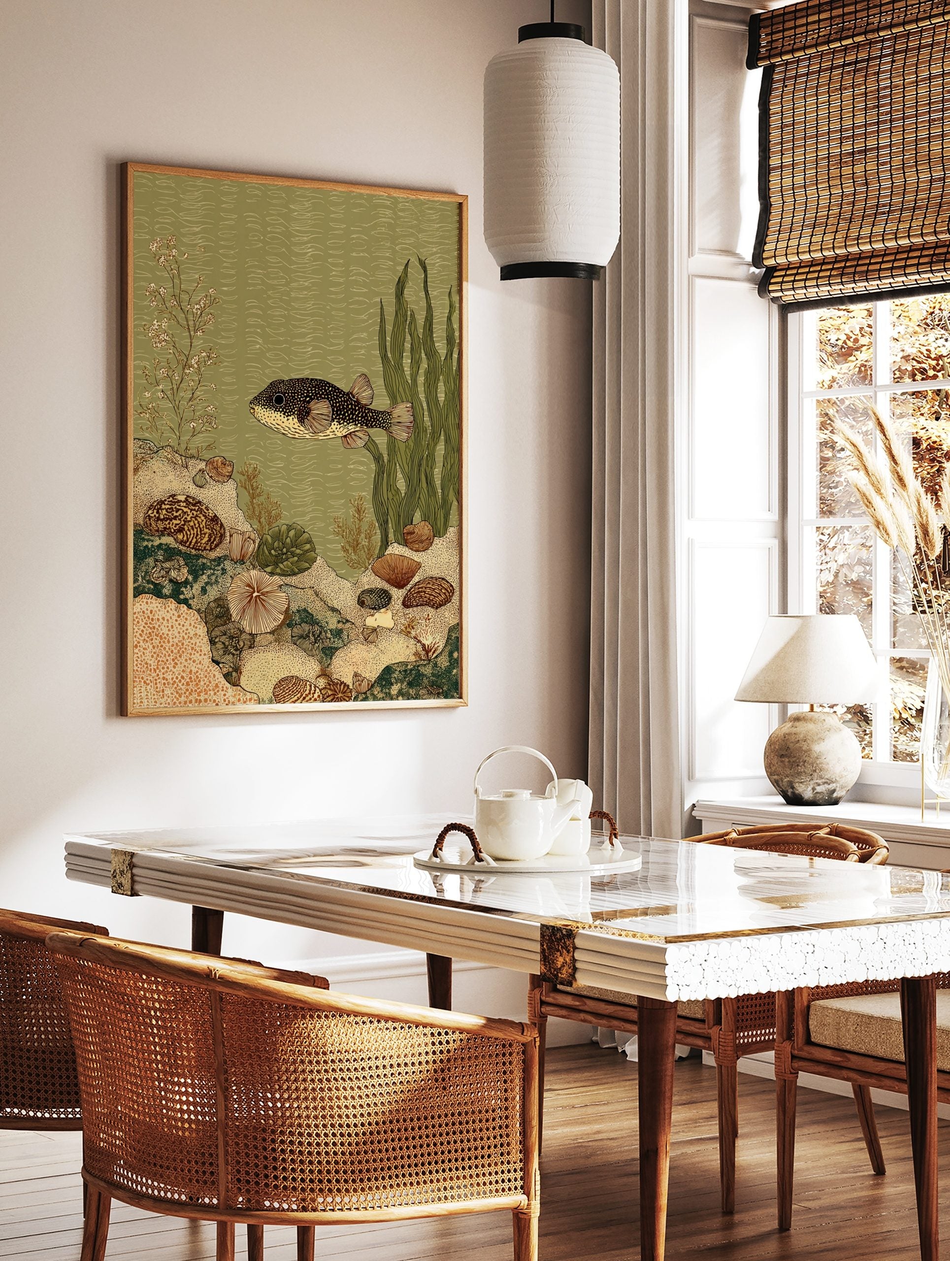 Illustrative pufferfish in an underwater scene with coral, shells, and seaweed in green and beige, in a styled room mockup