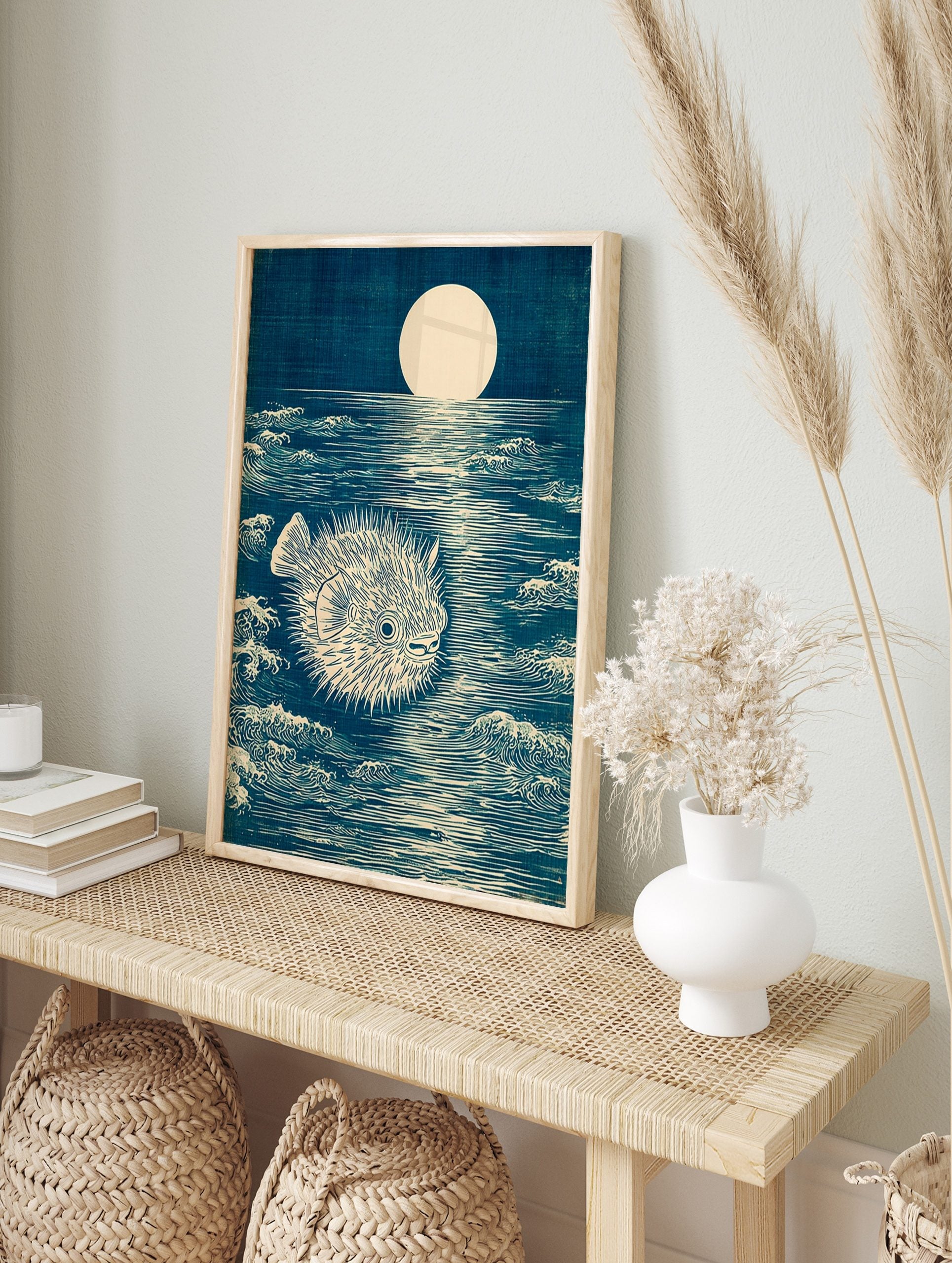 Japanese woodblock style art print of a spiky pufferfish in a dark blue moonlit ocean with, in an alternate framed mockup