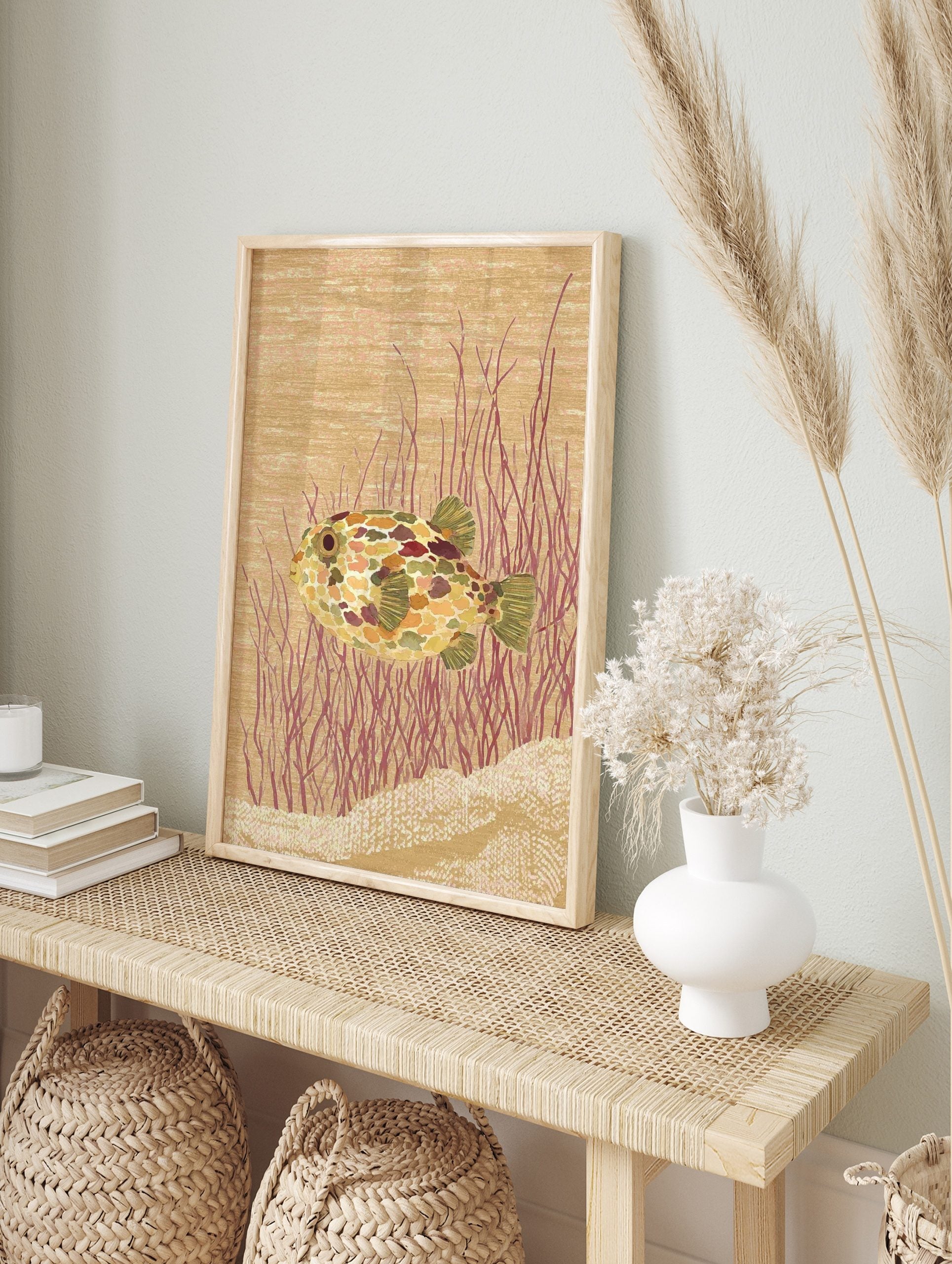 Illustrative pufferfish wall art print with colourful mottled skin, red underwater plants, in an alternate framed mockup