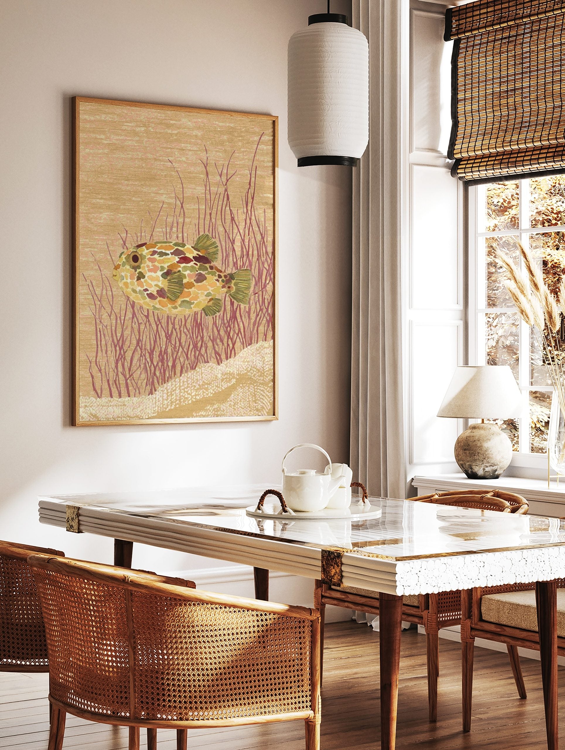 Illustrative pufferfish wall art print with colourful mottled skin, red underwater plants, and a, in a styled room mockup