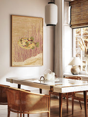 Illustrative pufferfish wall art print with colourful mottled skin, red underwater plants, and a, in a styled room mockup