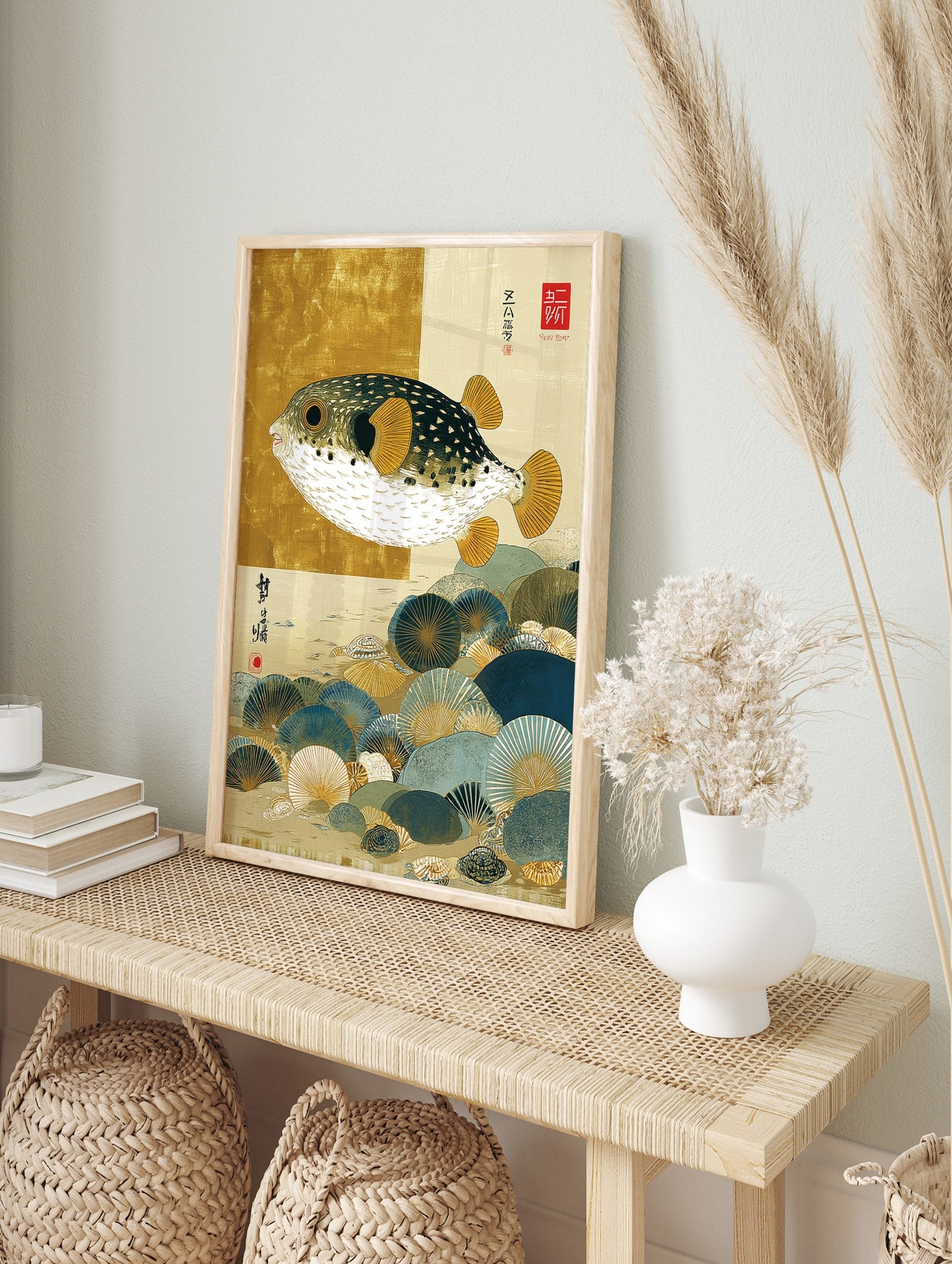 Japanese illustrative print of a pufferfish with gold fins swimming over blue and gold, in an alternate framed mockup
