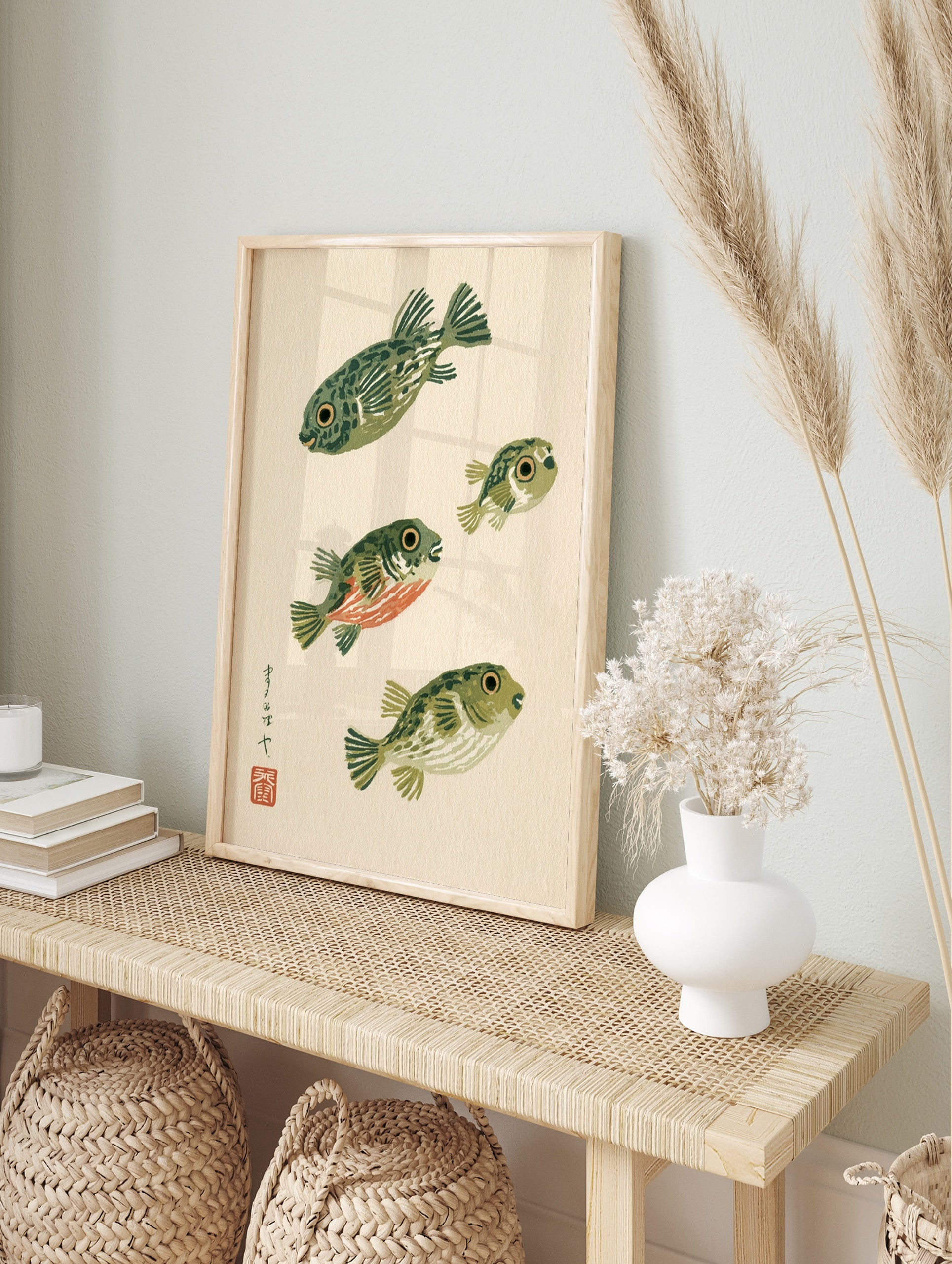Stylised pufferfish illustration with Japanese calligraphy and red seal on cream background, in an alternate framed mockup