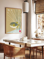 Japanese-inspired pufferfish wall art print with patterned fish and yellow fins amidst reeds on a, in a styled room mockup