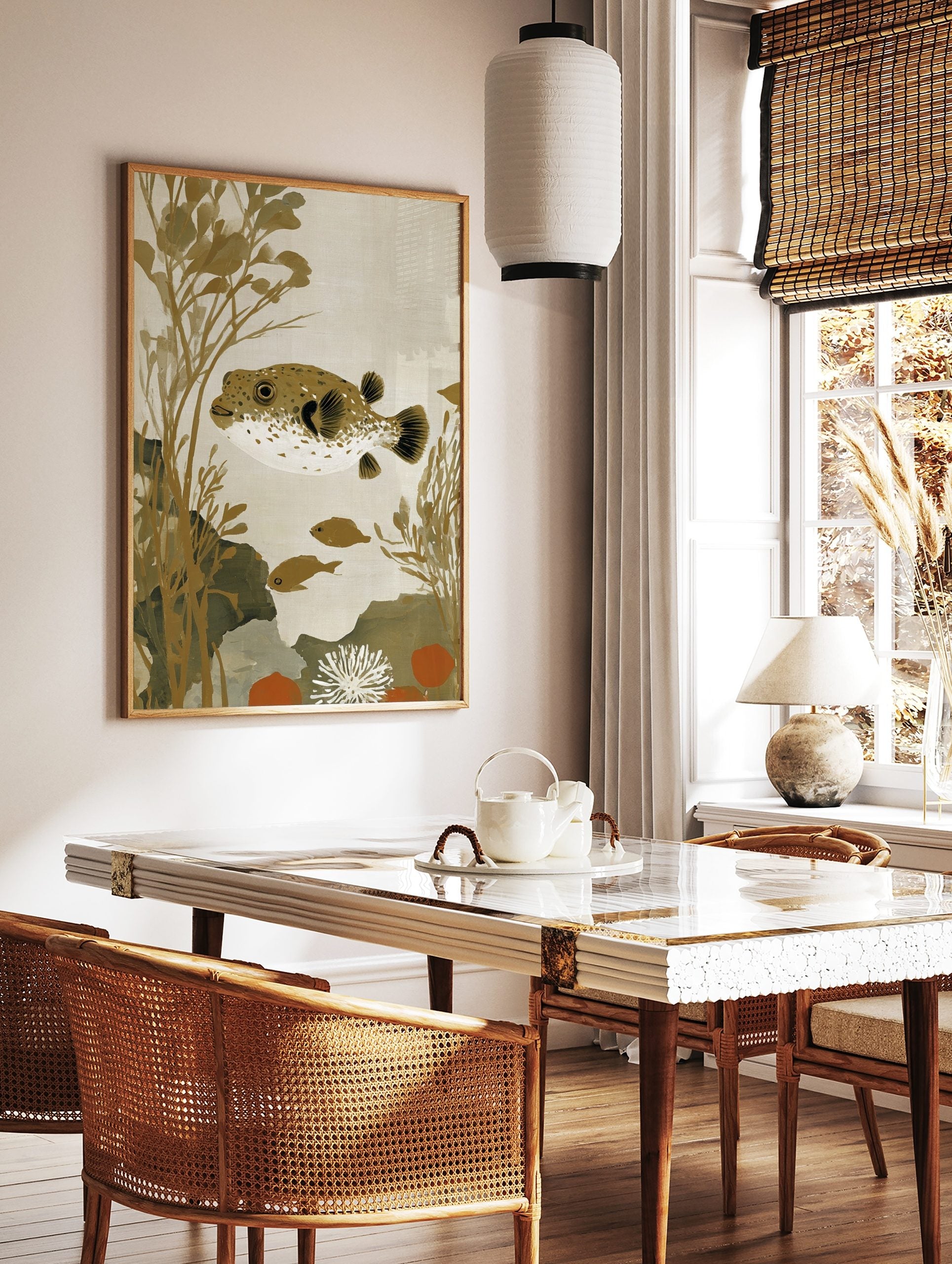 Illustrative pufferfish with brown spots and white underside, swimming amongst golden seaweed and, in a styled room mockup