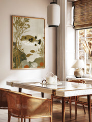Illustrative pufferfish with brown spots and white underside, swimming amongst golden seaweed and, in a styled room mockup