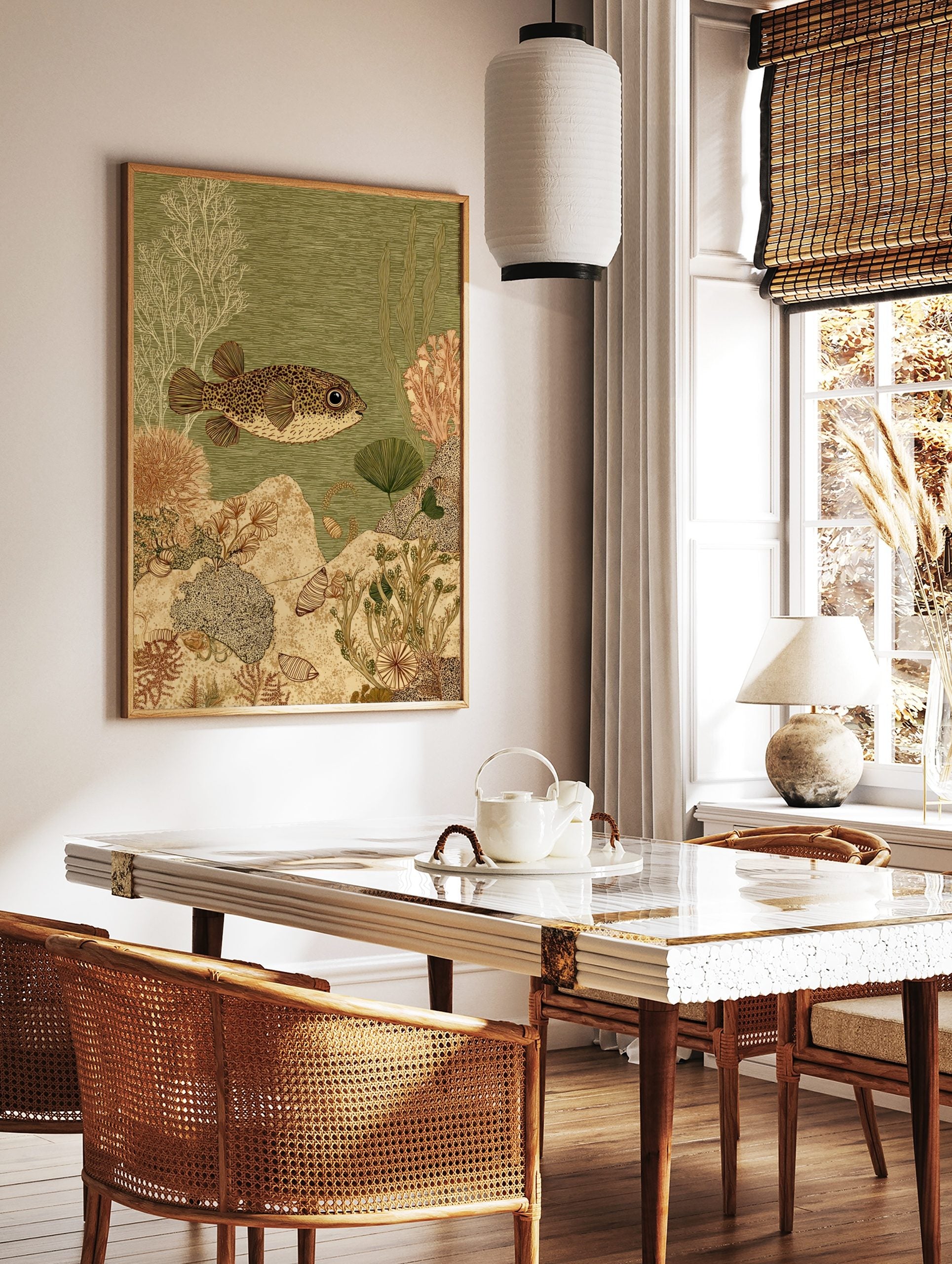 Spotted pufferfish swimming right in green water with white and brown coral, plants, and shells on, in a styled room mockup