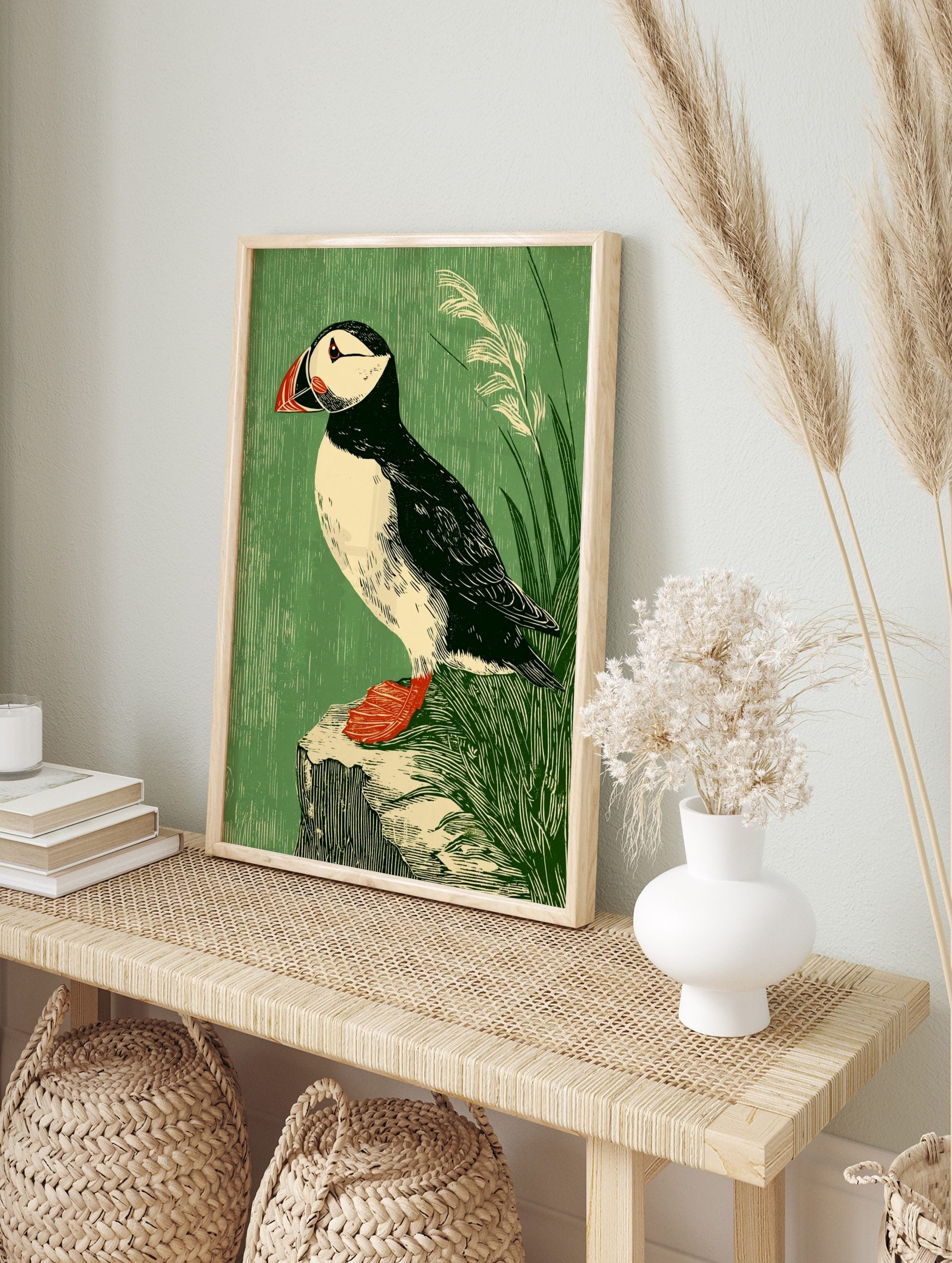 Illustrative puffin bird art print with black, white, red, and green tones, perched on a rock, in an alternate framed mockup