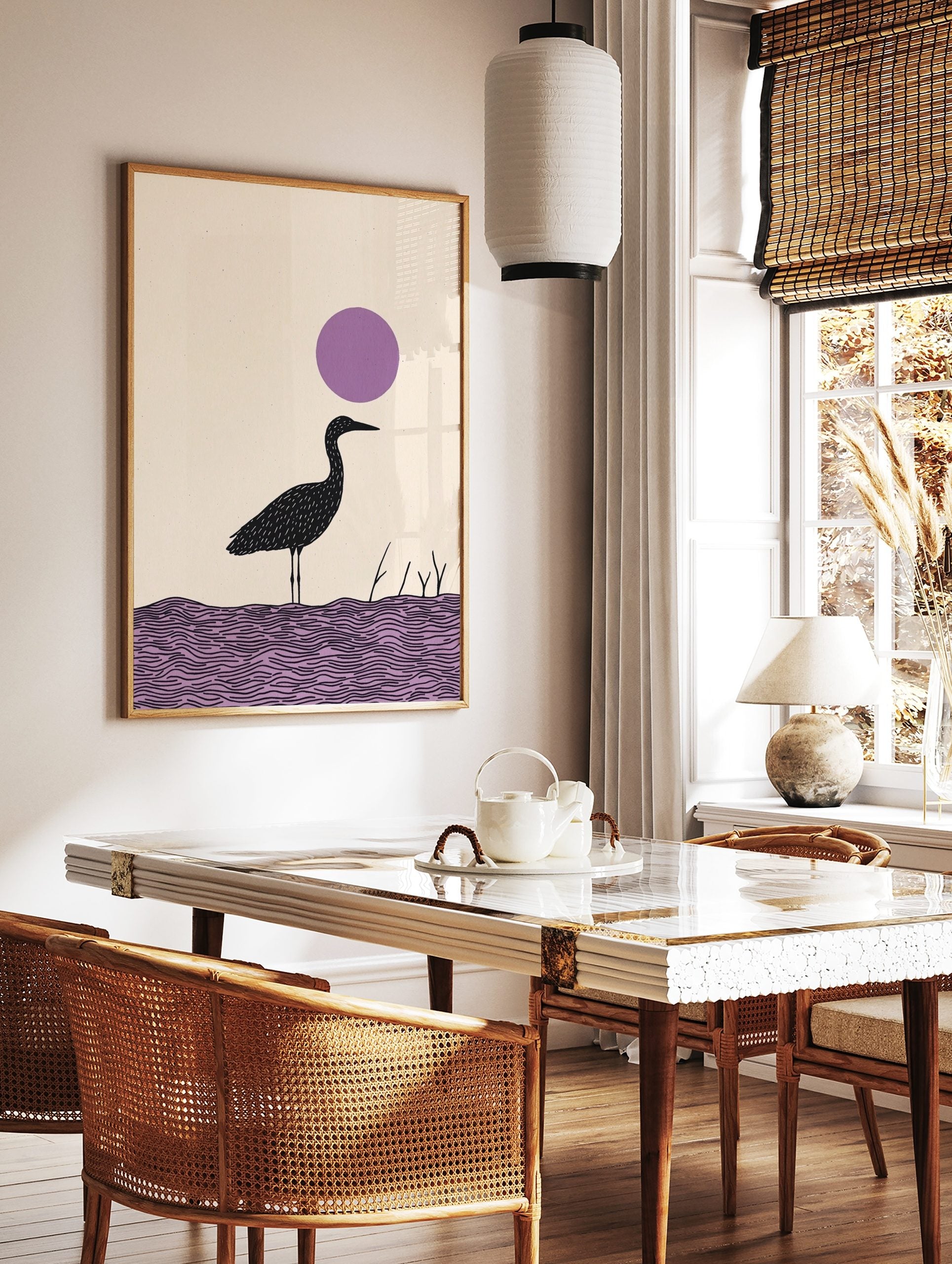 Minimalist black heron bird illustration standing in purple water with a large purple circle in the, in a styled room mockup