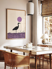 Minimalist black heron bird illustration standing in purple water with a large purple circle in the, in a styled room mockup