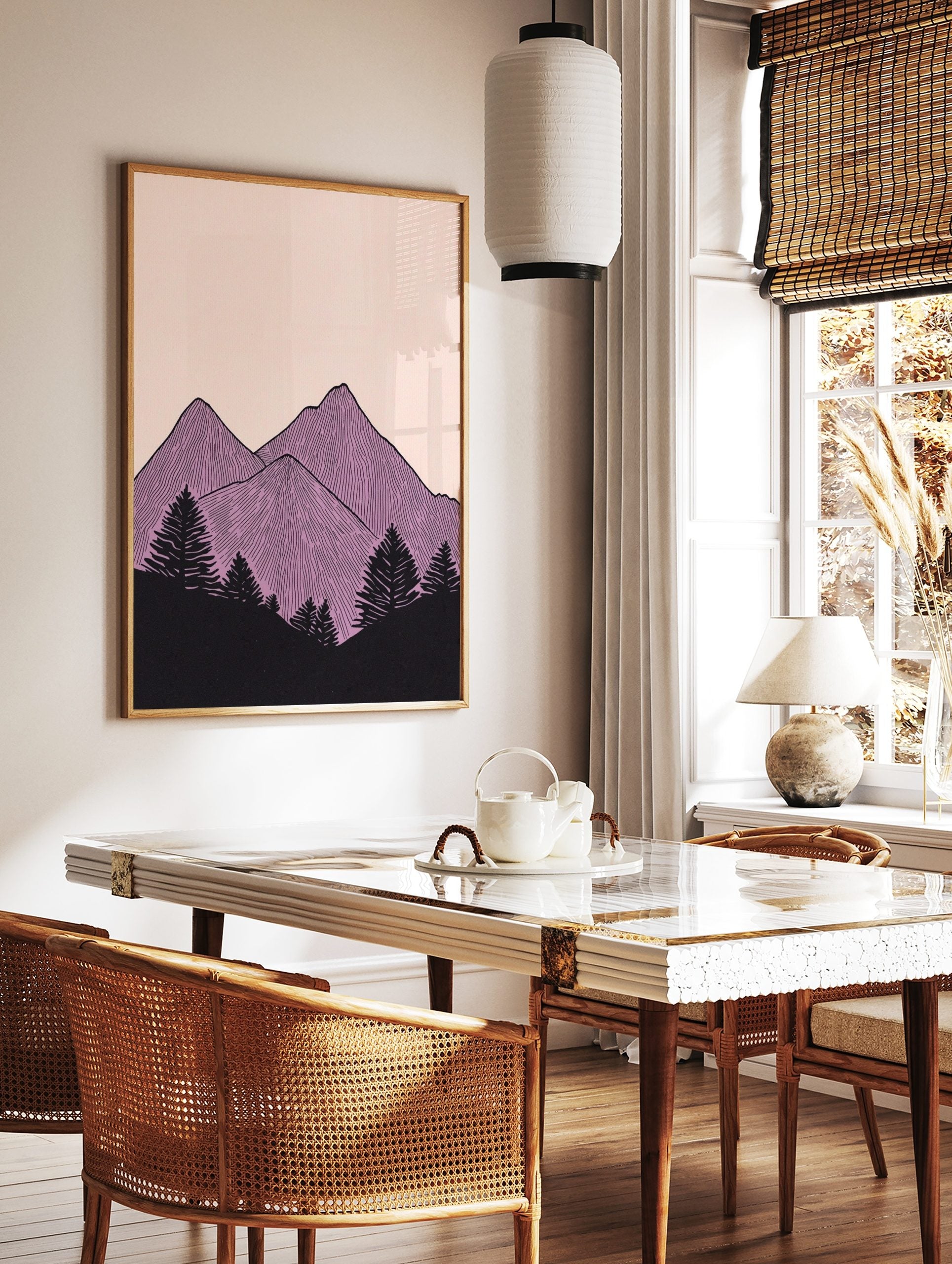 Illustrative purple mountain peaks with vertical lines and black pine trees on a pale pink, in a styled room mockup