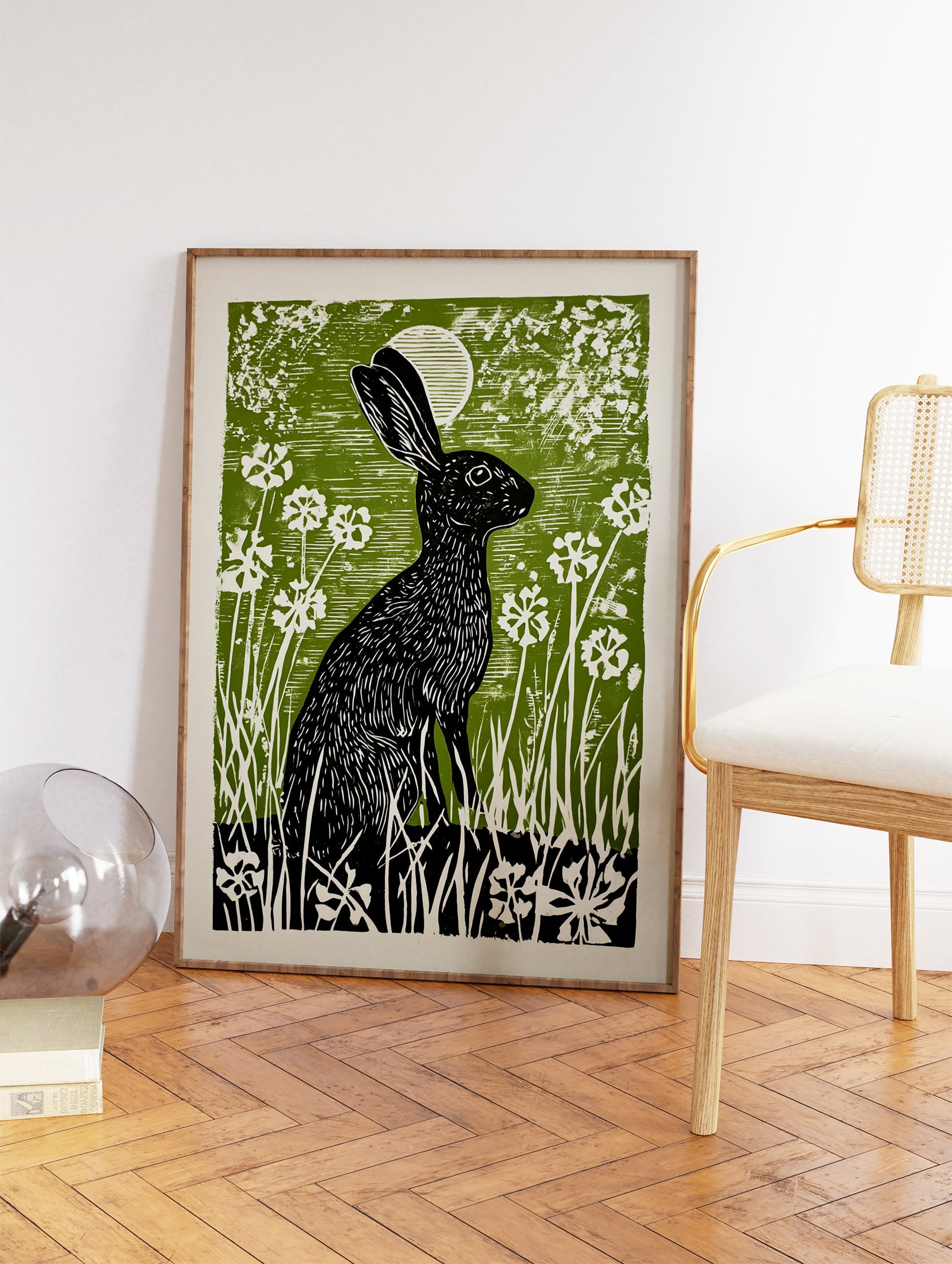 Black rabbit linocut print in a green field with white flowers and a moon, illustrative wall art. - Image 2