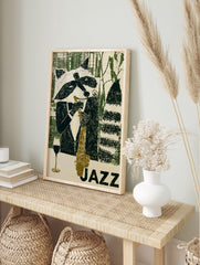 Illustration of a raccoon playing a saxophone with a wine glass, titled JAZZ in green and, in an alternate framed mockup