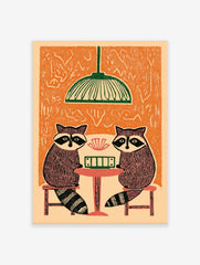 Illustrative print of two raccoons playing cards at a table under a green lamp, with an orange background