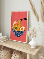 Illustration of ramen noodles styled like the Great Wave in a blue bowl on a red background, in an alternate framed mockup
