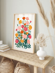 Botanical illustration of vibrant pink, orange, and yellow Ranunculus flowers with green, in an alternate framed mockup