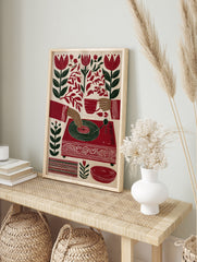Illustration of hands playing a record player with red tulips and botanical leaves on a cream, in an alternate framed mockup