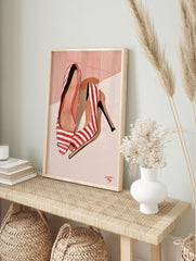 Fashion illustration of red and white striped high heels on a soft peach background, in an alternate framed mockup