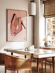 Fashion illustration of red and white striped high heels on a soft peach background, in a styled room mockup