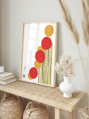Abstract art print with vertical stack of red and yellow textured circles on cream background, in an alternate framed mockup