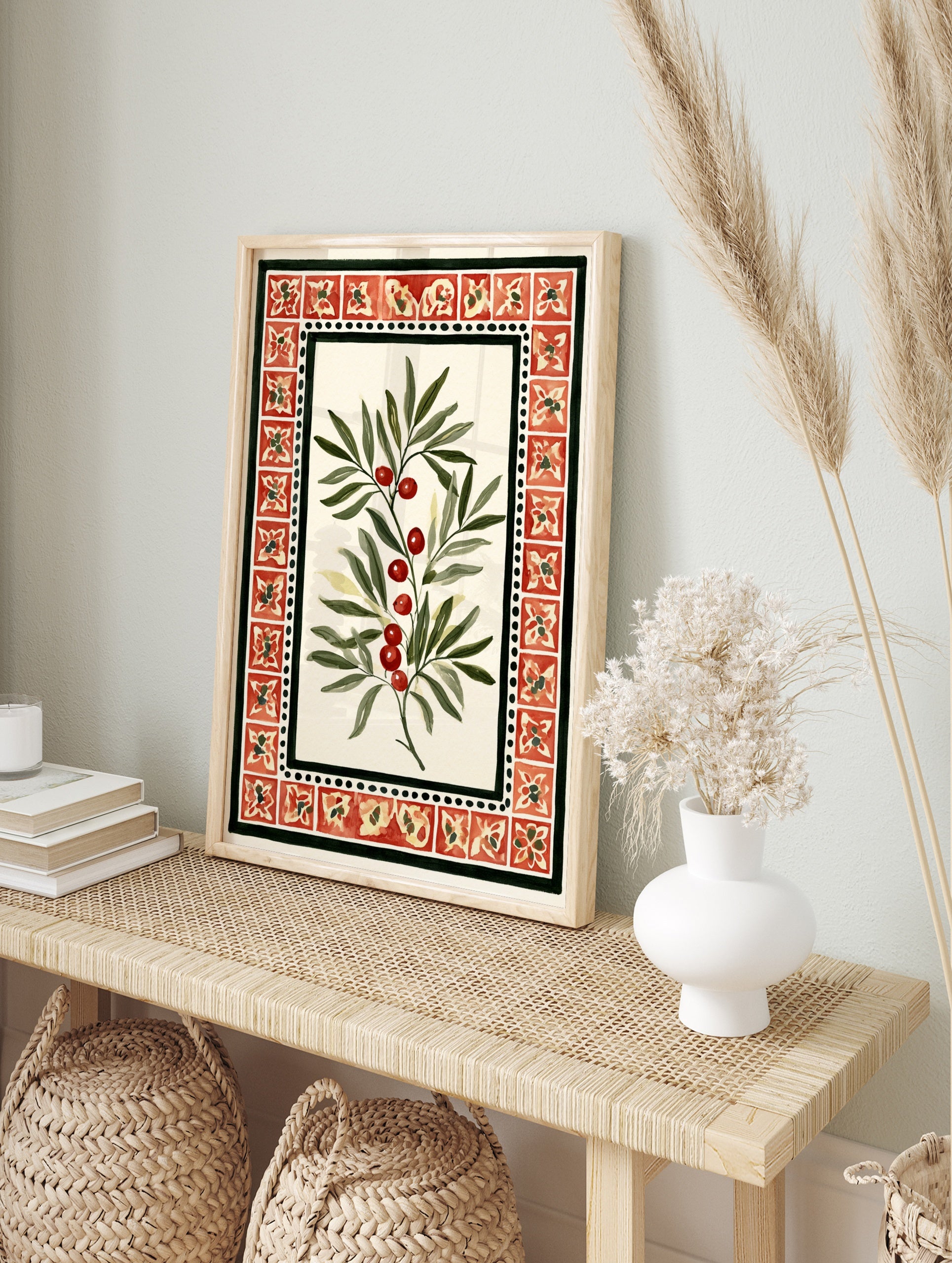 Botanical illustration of a branch with red berries and green leaves within a red tile border, in an alternate framed mockup