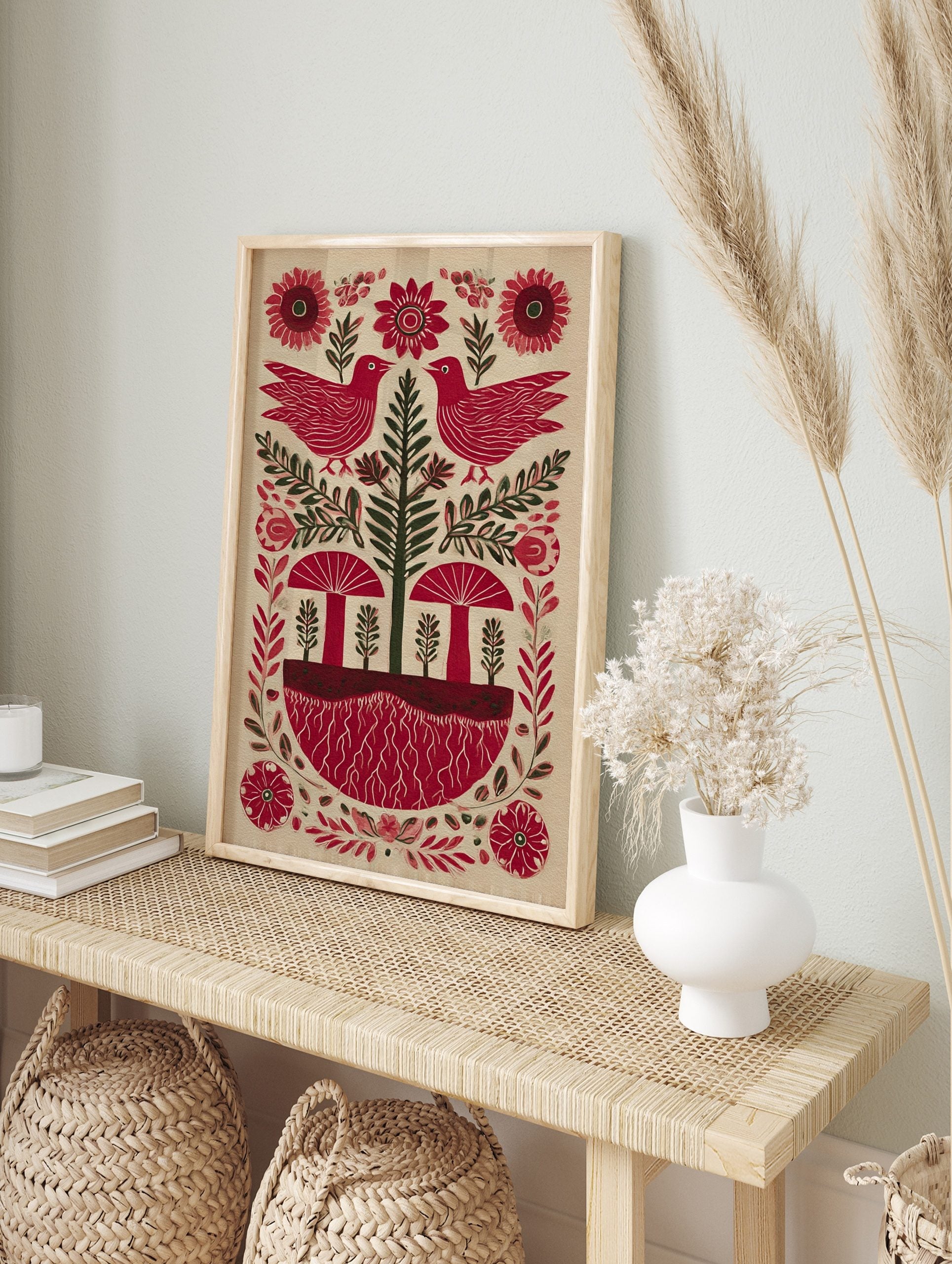 Red bird and mushroom folk art print with green tree, red roots, and flowers on a light, in an alternate framed mockup