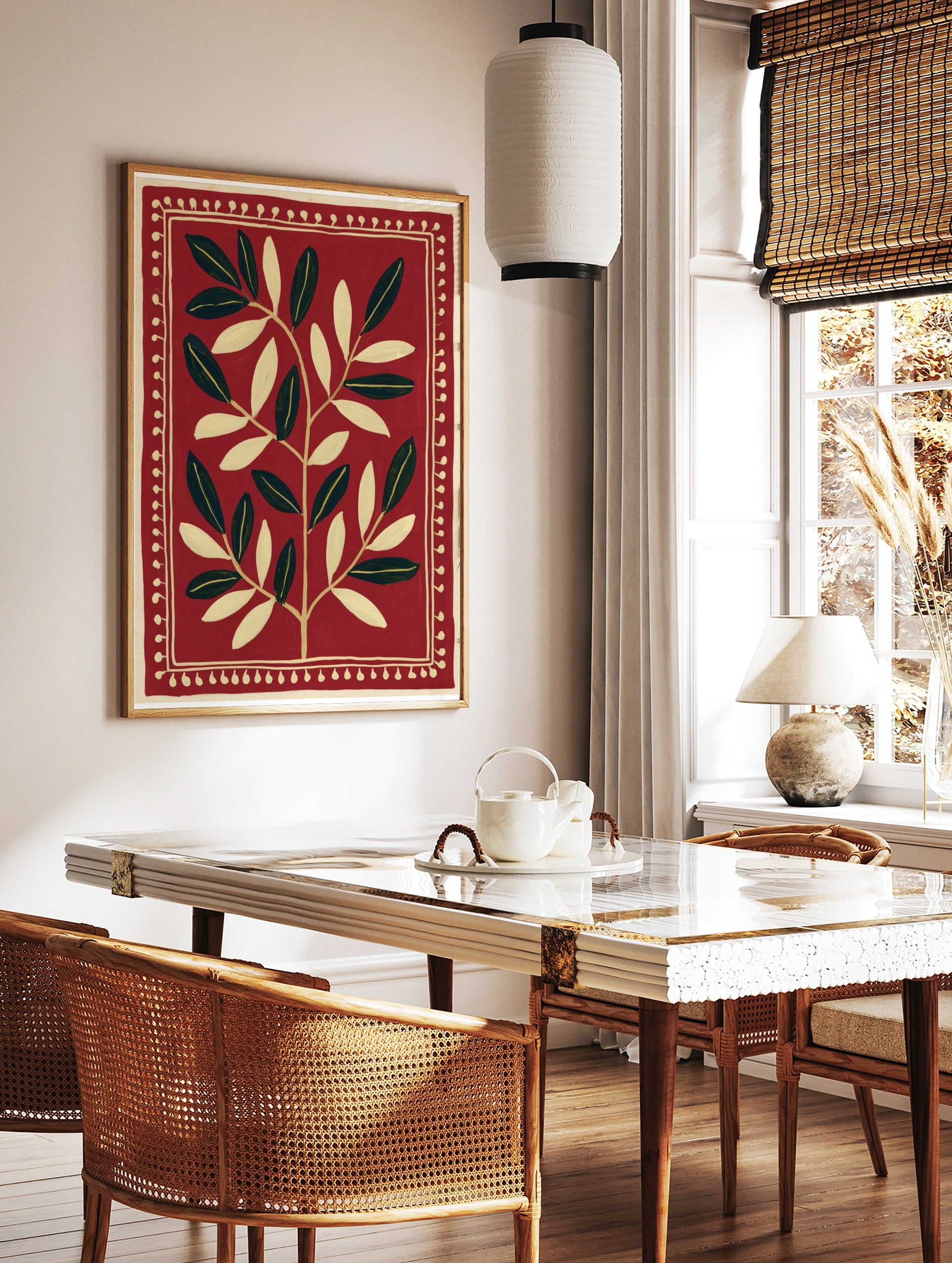 Symmetrical botanical leaf illustration in cream on a deep red background with a decorative dotted, in a styled room mockup