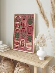Decorative folk art print showing six patterned vases with botanical flowers and leaves in, in an alternate framed mockup