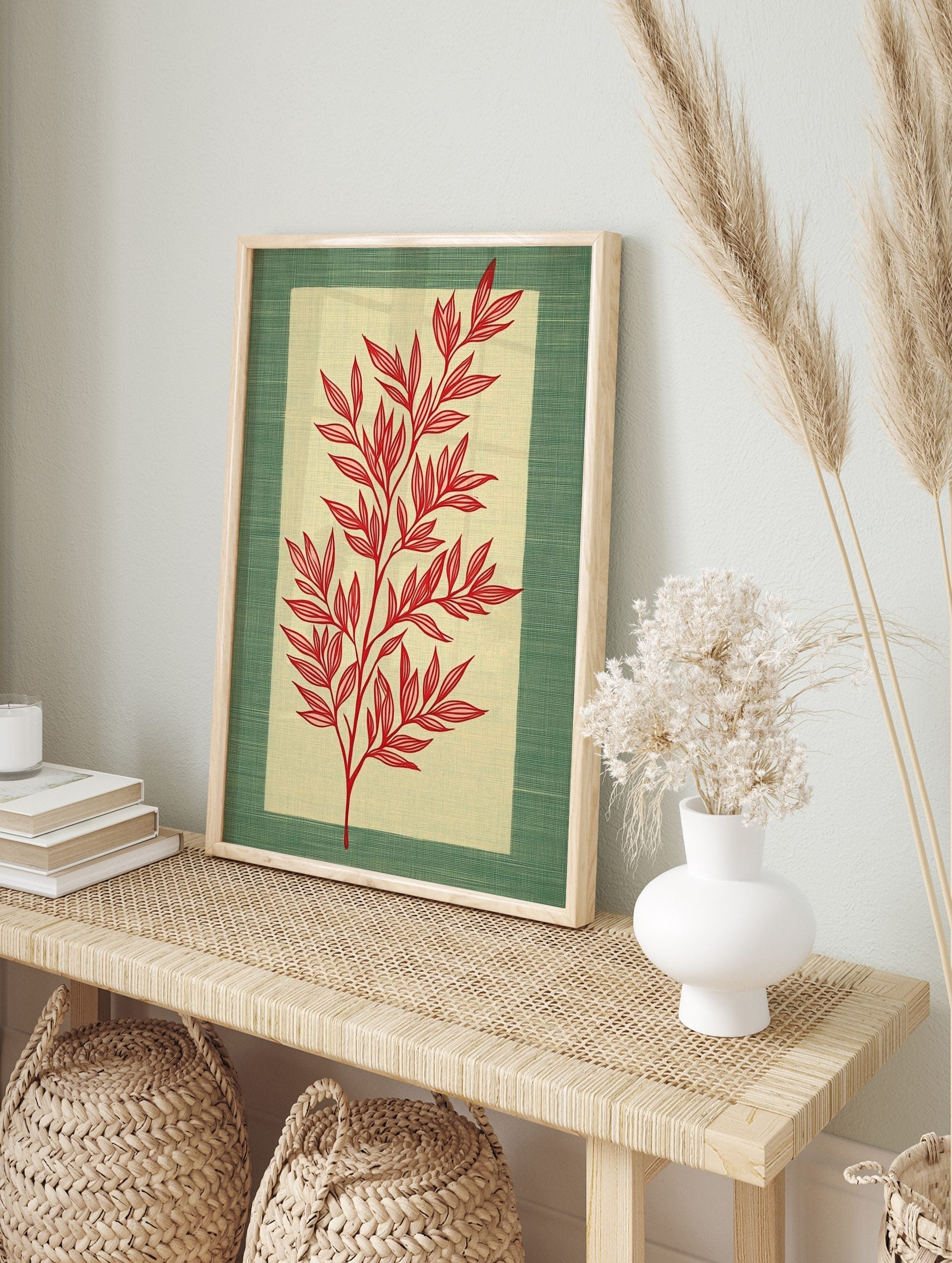 Red botanical illustration of a leafy stem on a pale beige panel, framed by a textured green, in an alternate framed mockup