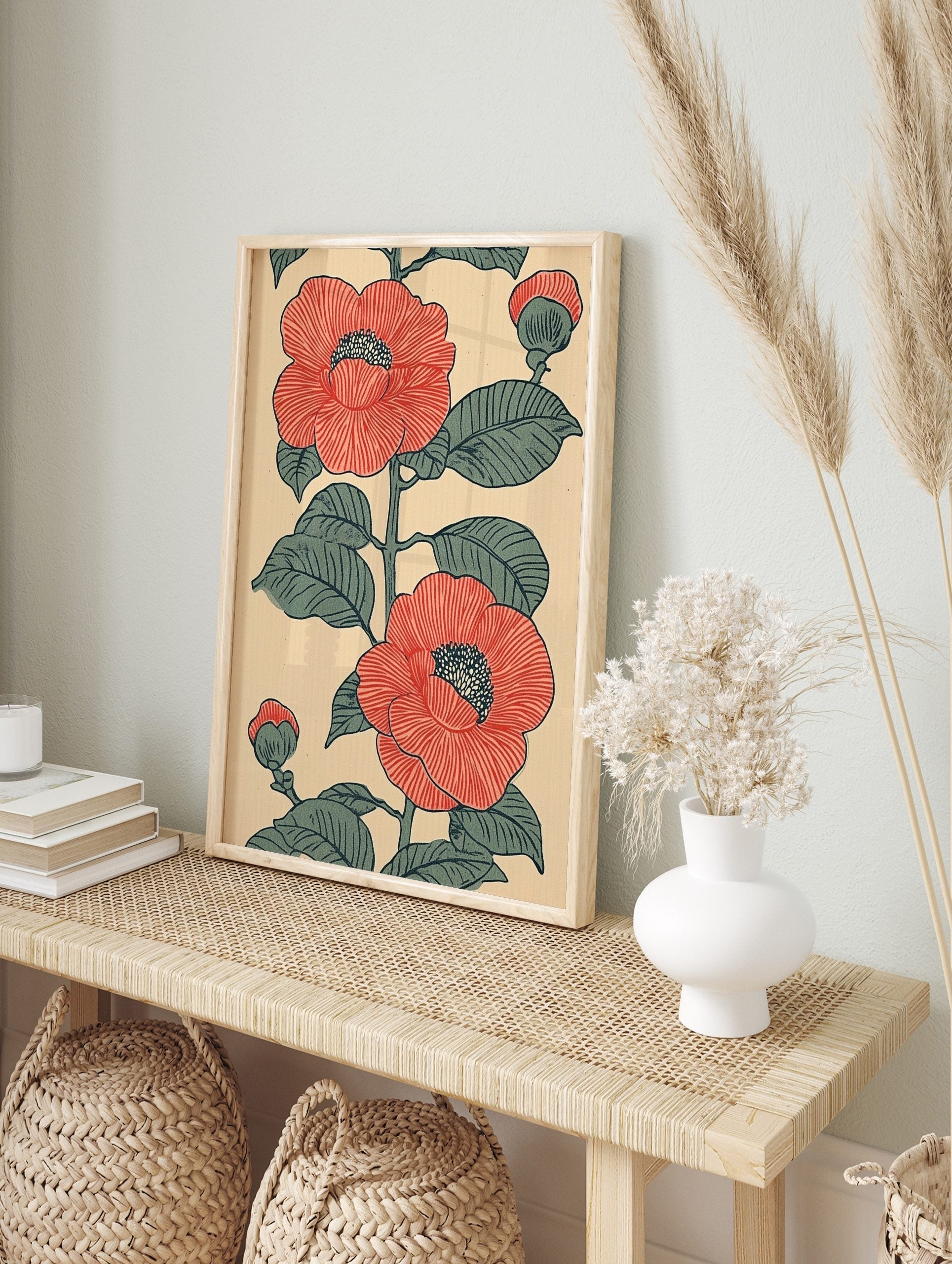 Red camellia botanical illustration with green leaves and buds on a beige background, in an, in an alternate framed mockup