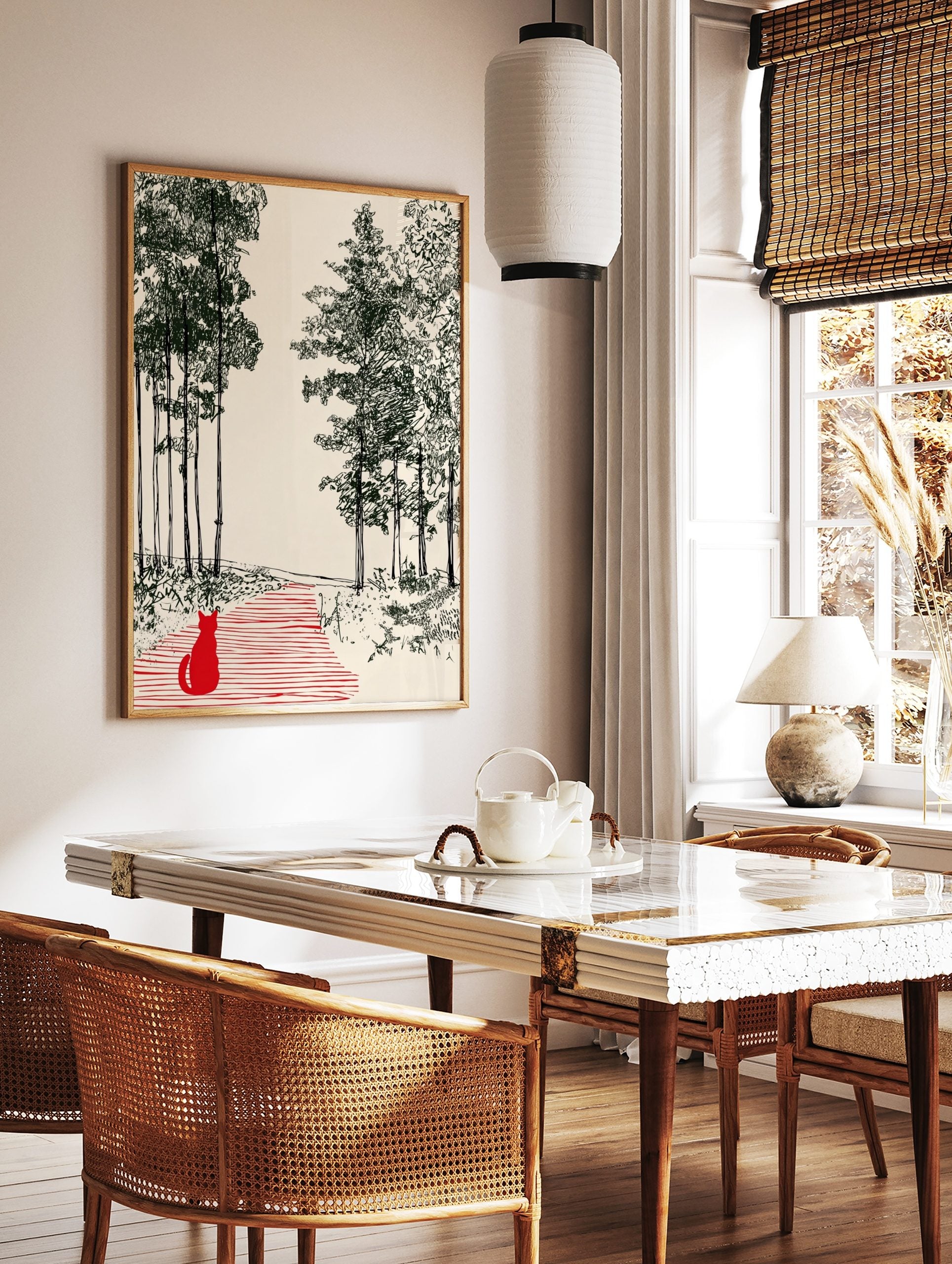 Illustrative print of a red cat on a striped path in a dark green forest on a cream background, in a styled room mockup