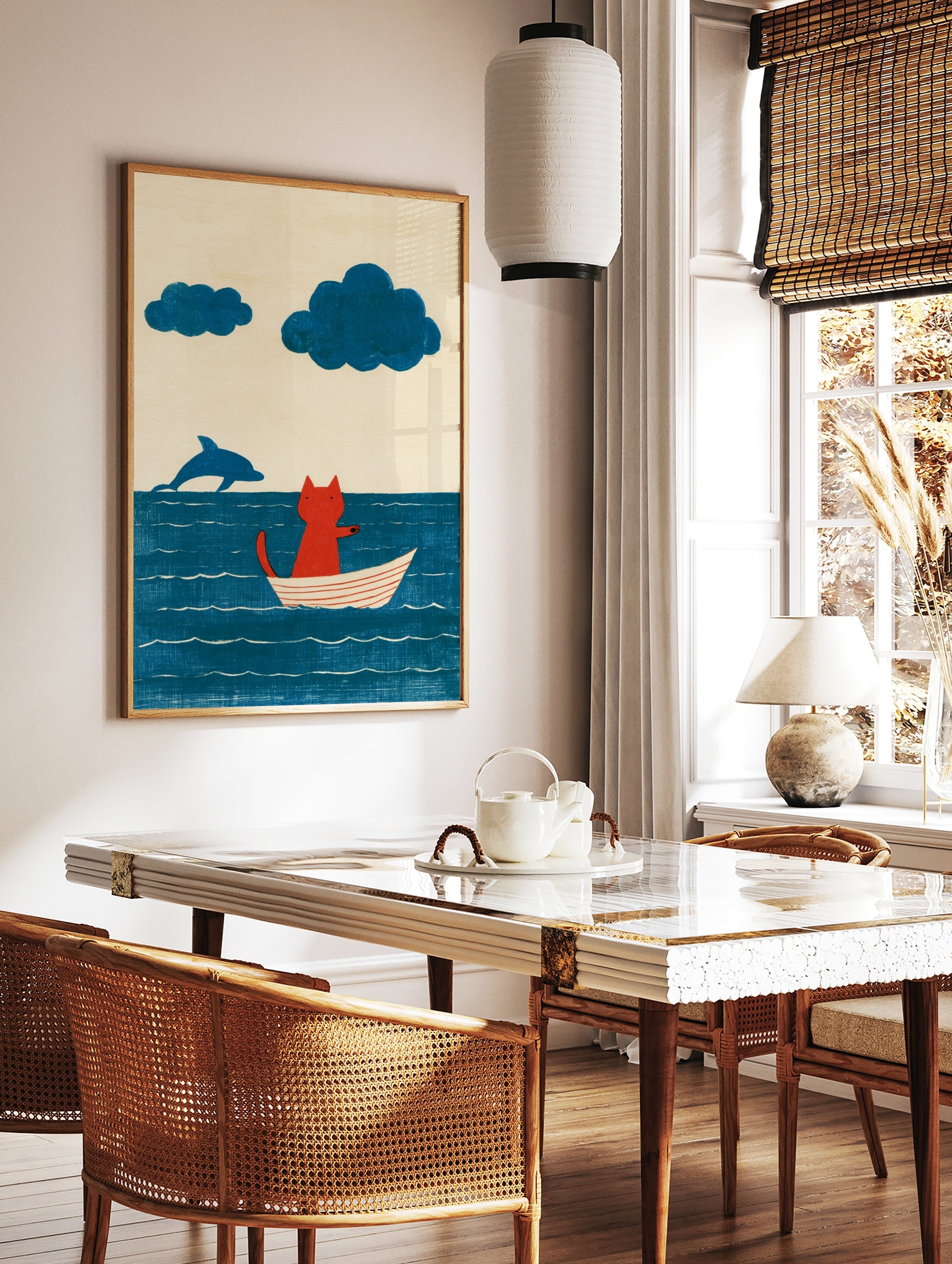 Illustration of a red cat sitting in a white boat on a blue sea with a jumping dolphin and two blue, in a styled room mockup