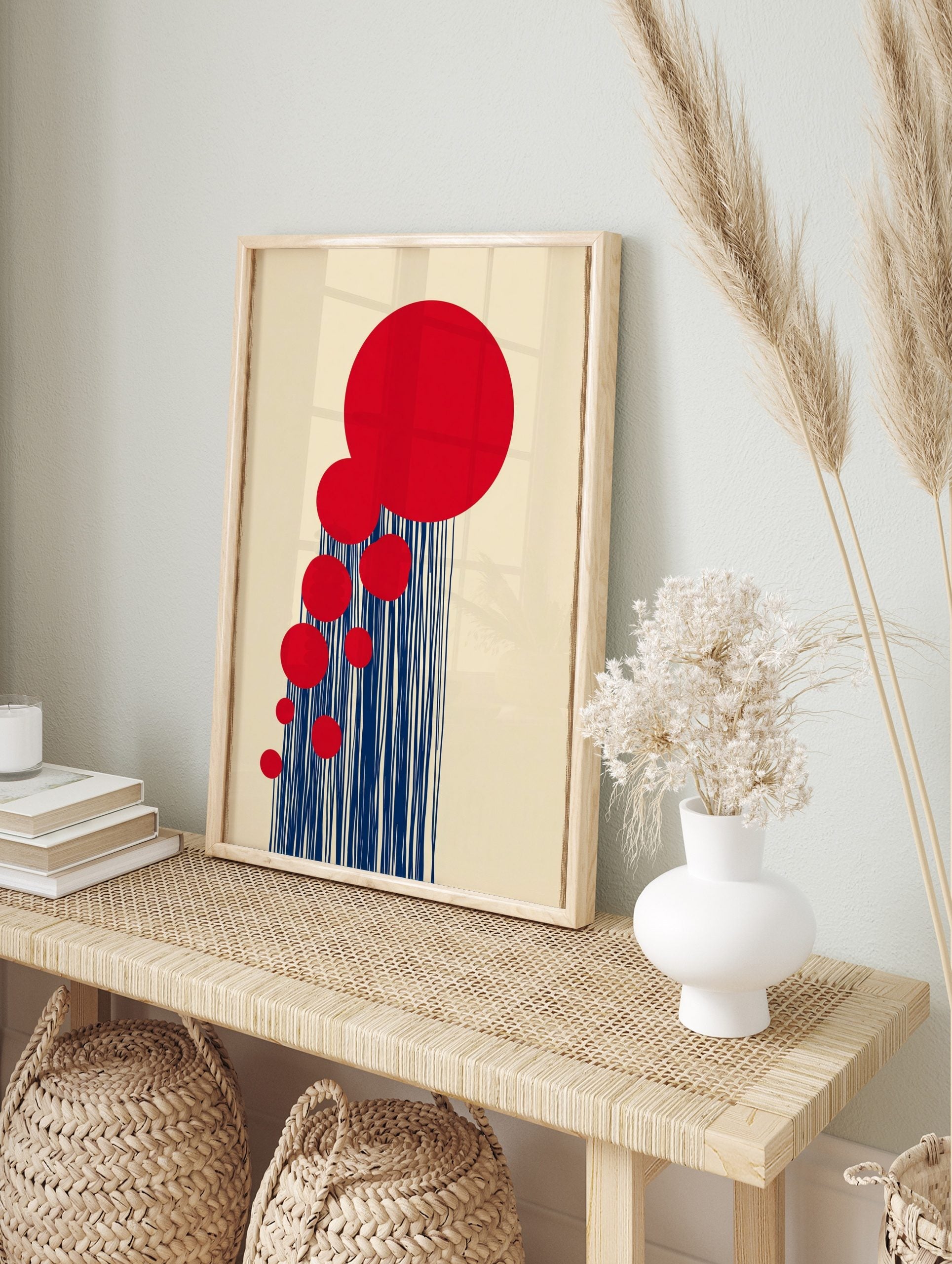 Abstract wall art with large red circles and vertical navy blue lines on a beige background, in an alternate framed mockup