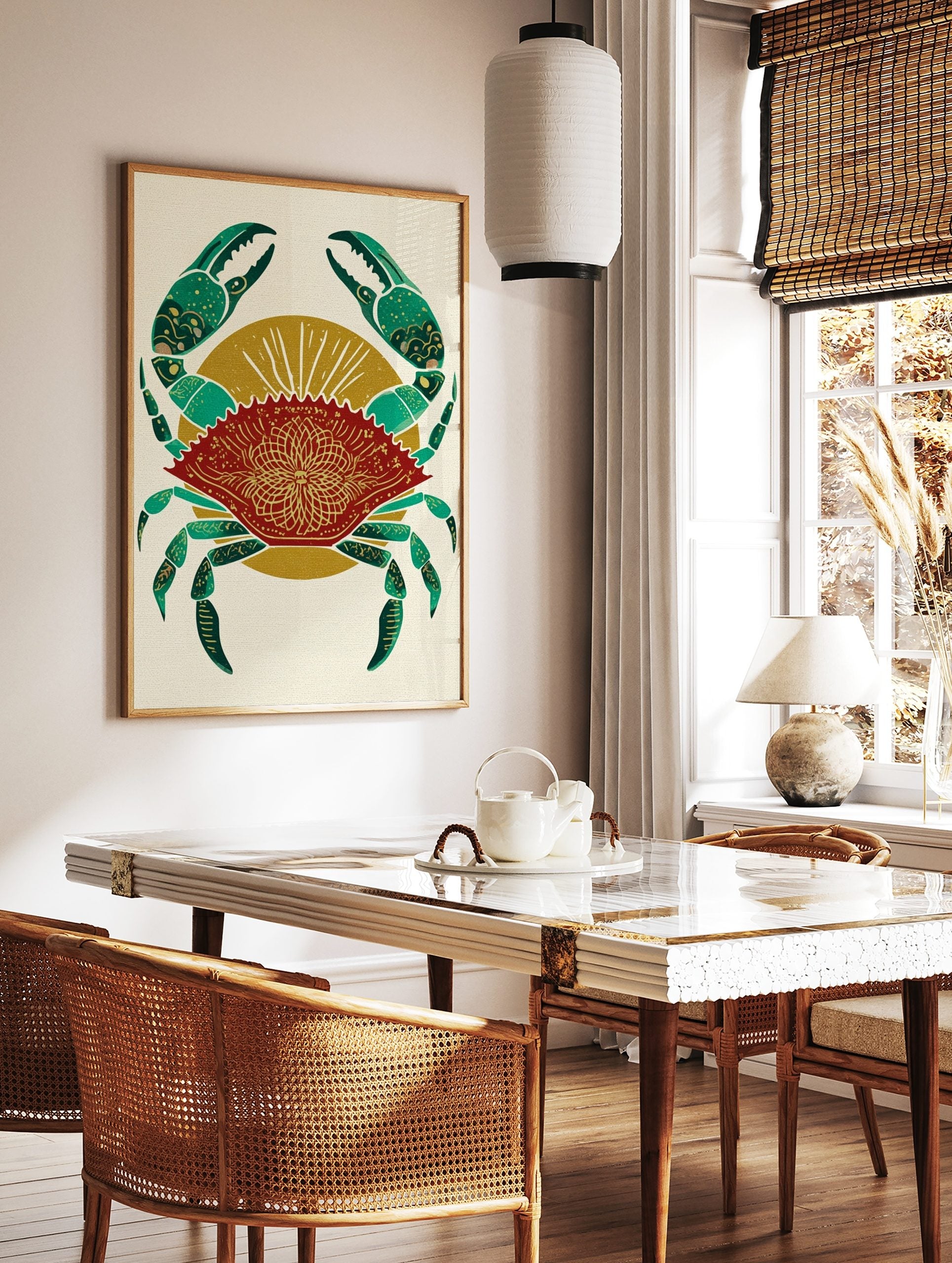 Red crab illustration with green claws and gold mandala pattern on shell, against a golden sunburst, in a styled room mockup