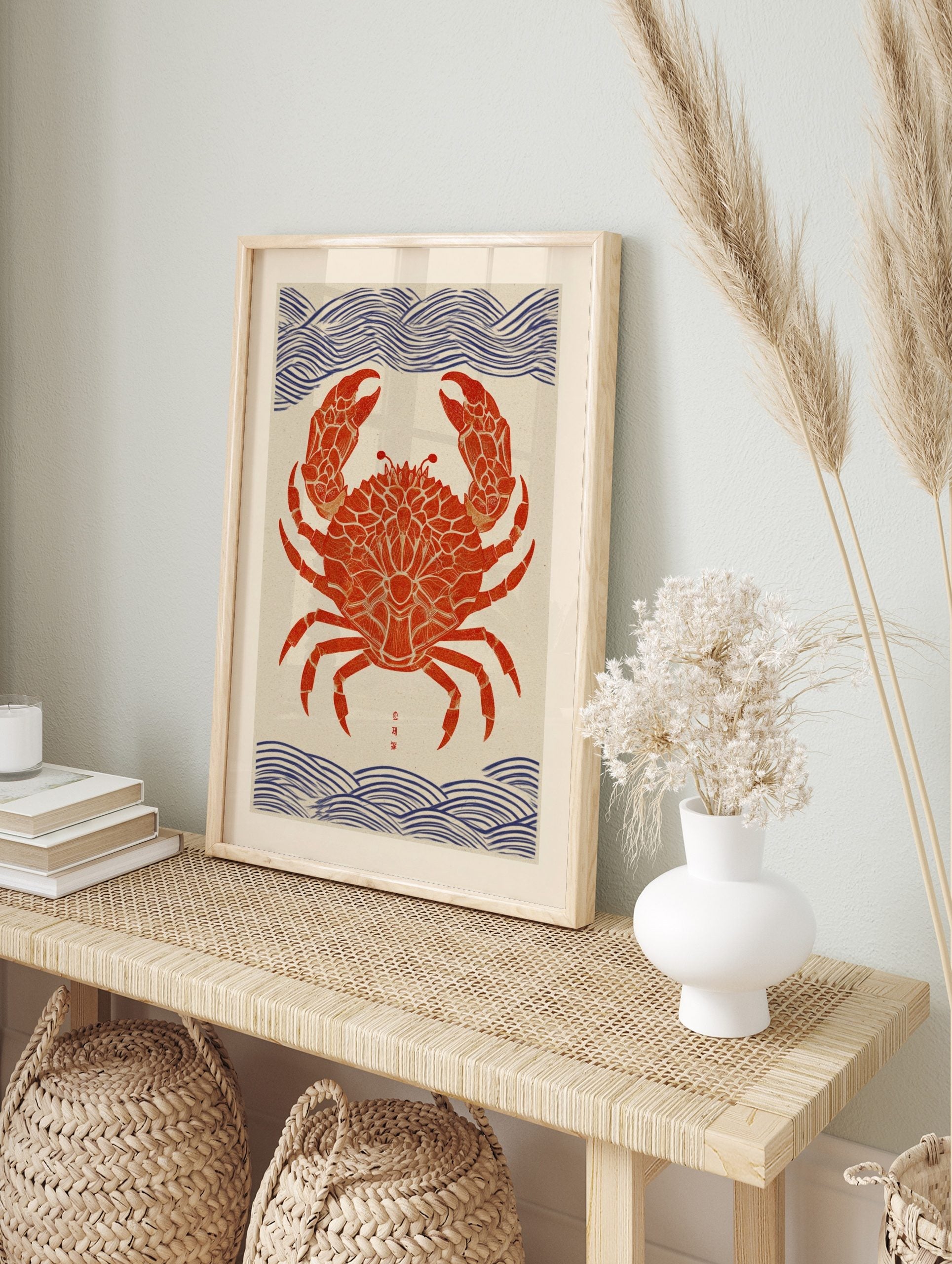 Red crab wall art print with ornate patterns, blue wave motifs, and Japanese characters in, in an alternate framed mockup