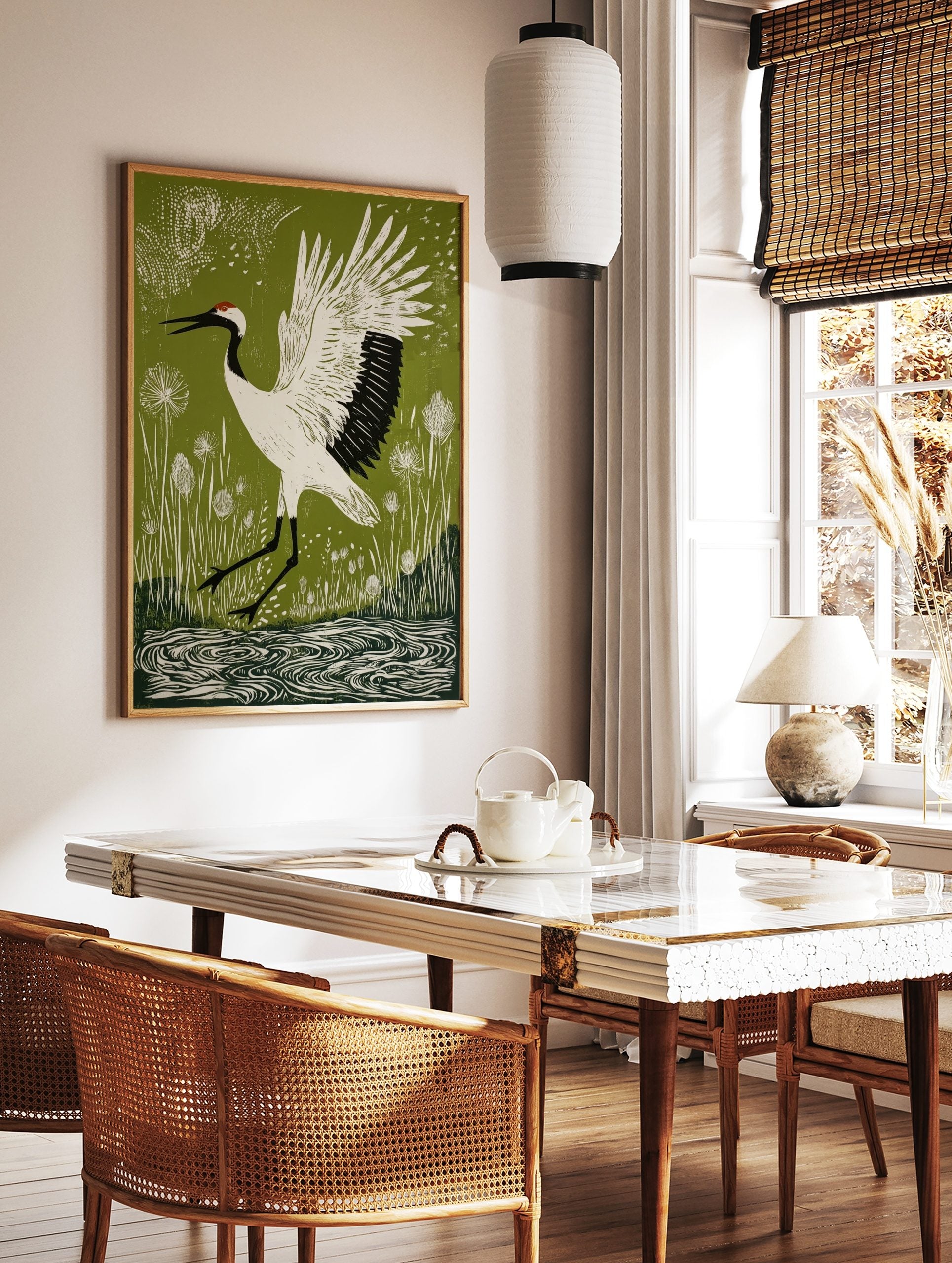 Linocut style print of a white red-crowned crane with black markings and red crown, wings spread, in a styled room mockup