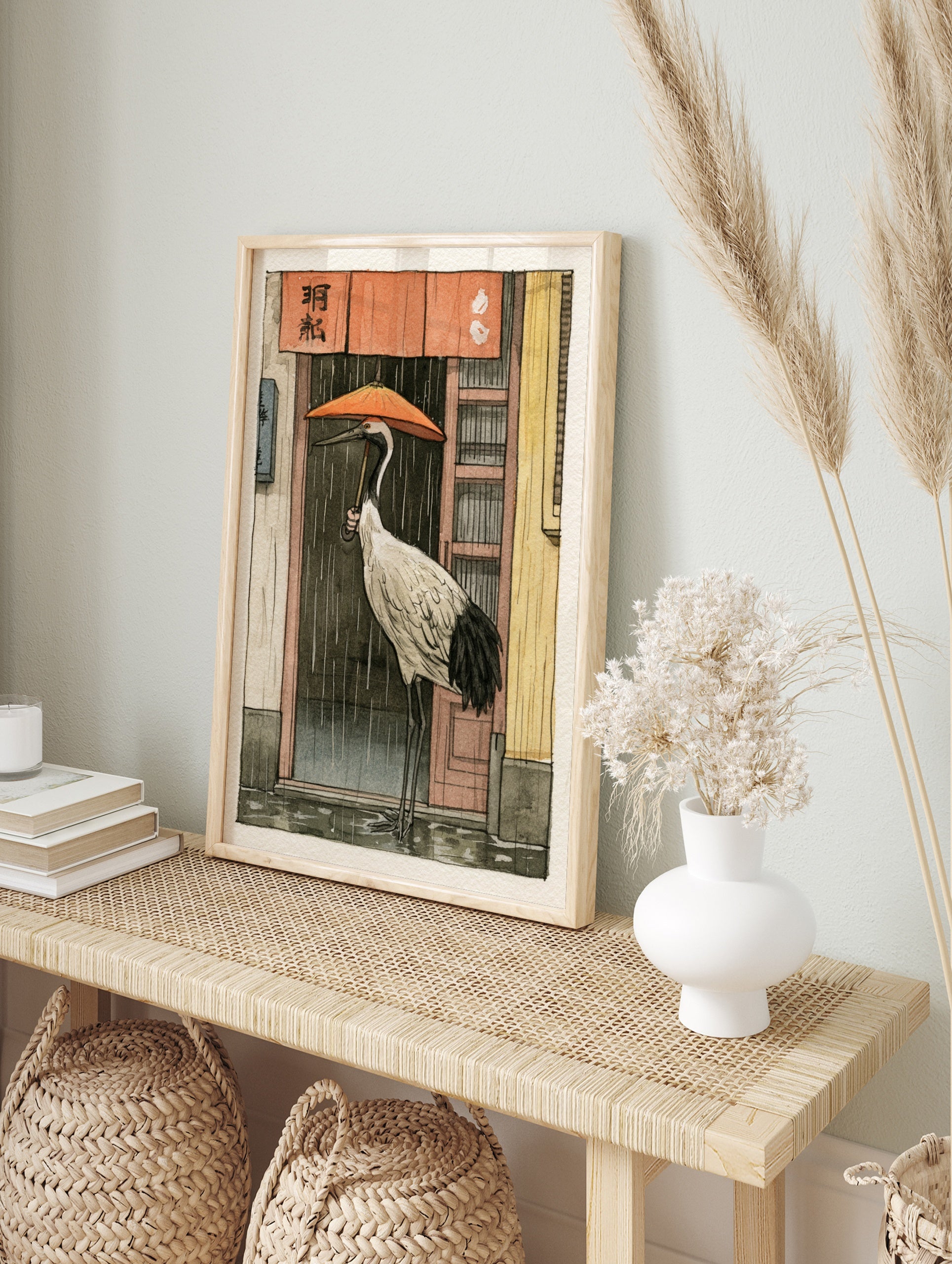 Red-crowned crane holding an orange umbrella standing in the rain before a shop with a red, in an alternate framed mockup
