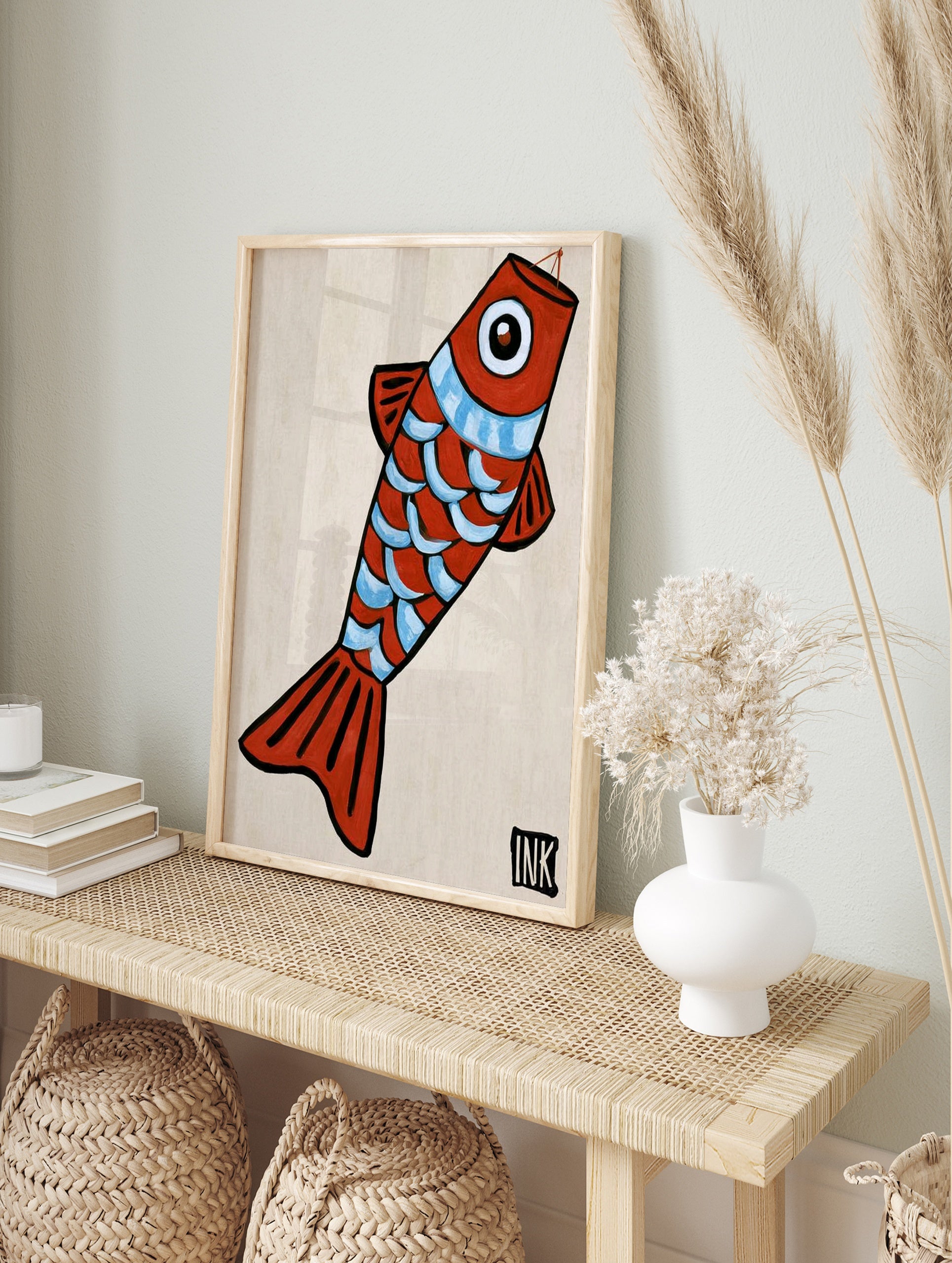 Stylized red fish illustration with blue scales and an ink signature, minimalist art print on, in an alternate framed mockup