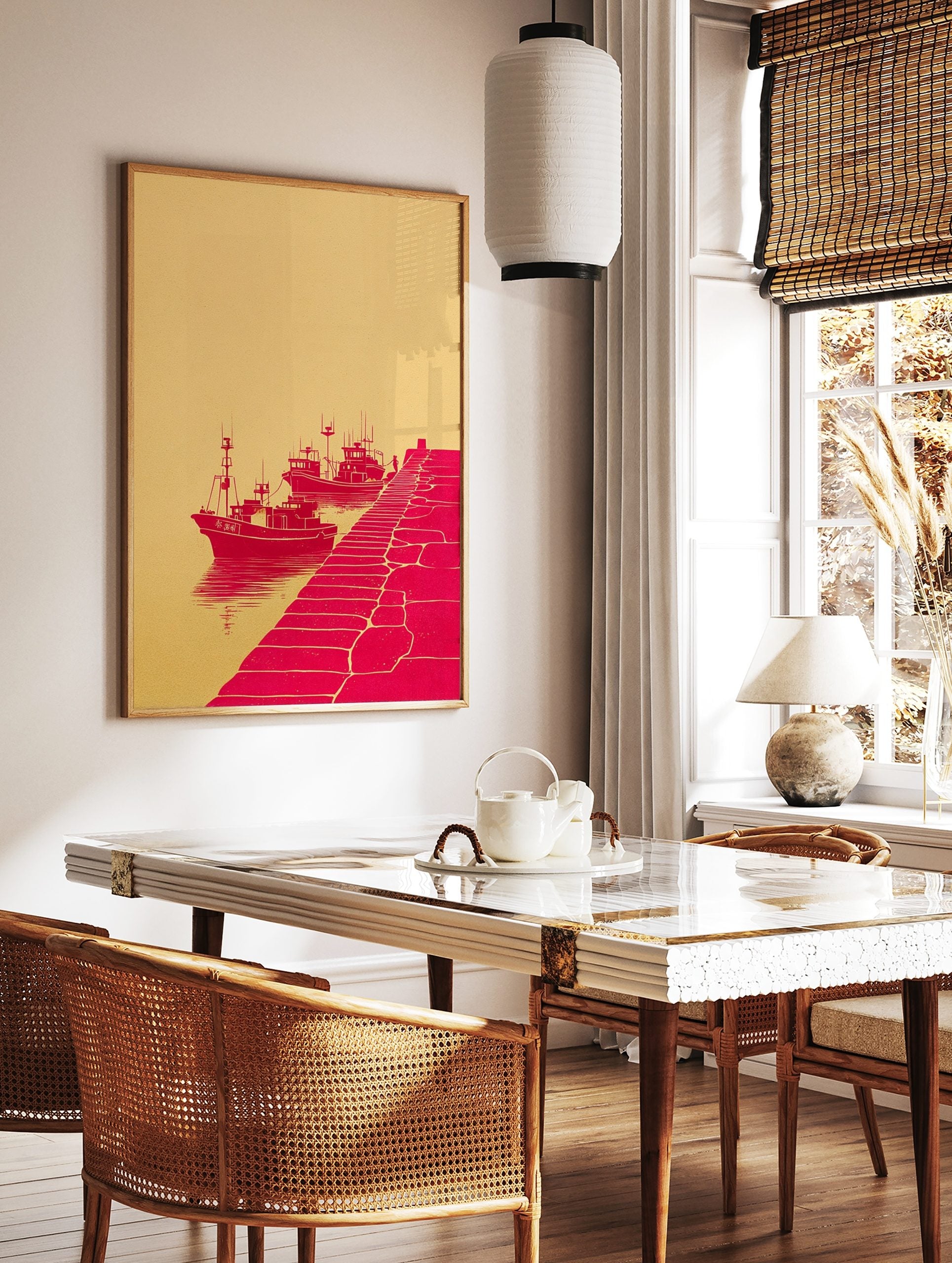 Red illustrative print of three fishing boats docked by a pier with a figure, against a beige, in a styled room mockup