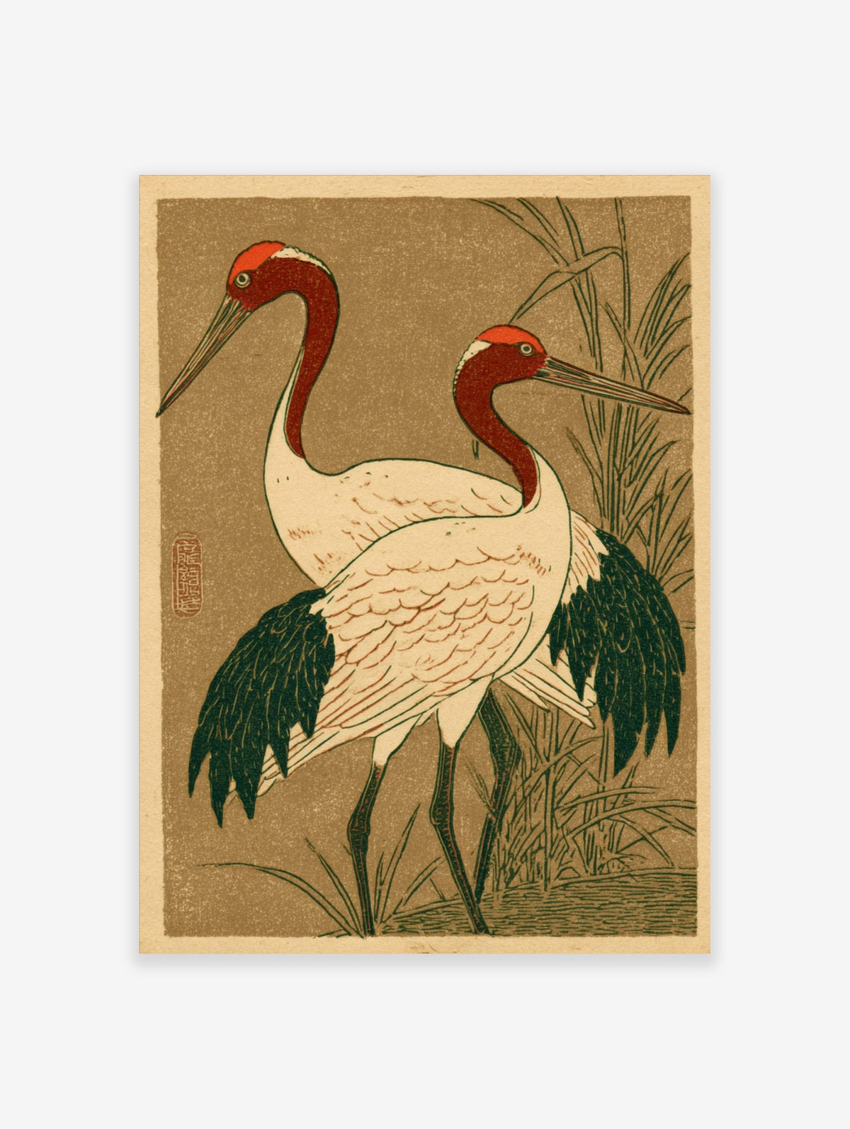Japanese illustrative print of two red-headed cranes with white bodies and dark wings, standing in green reeds