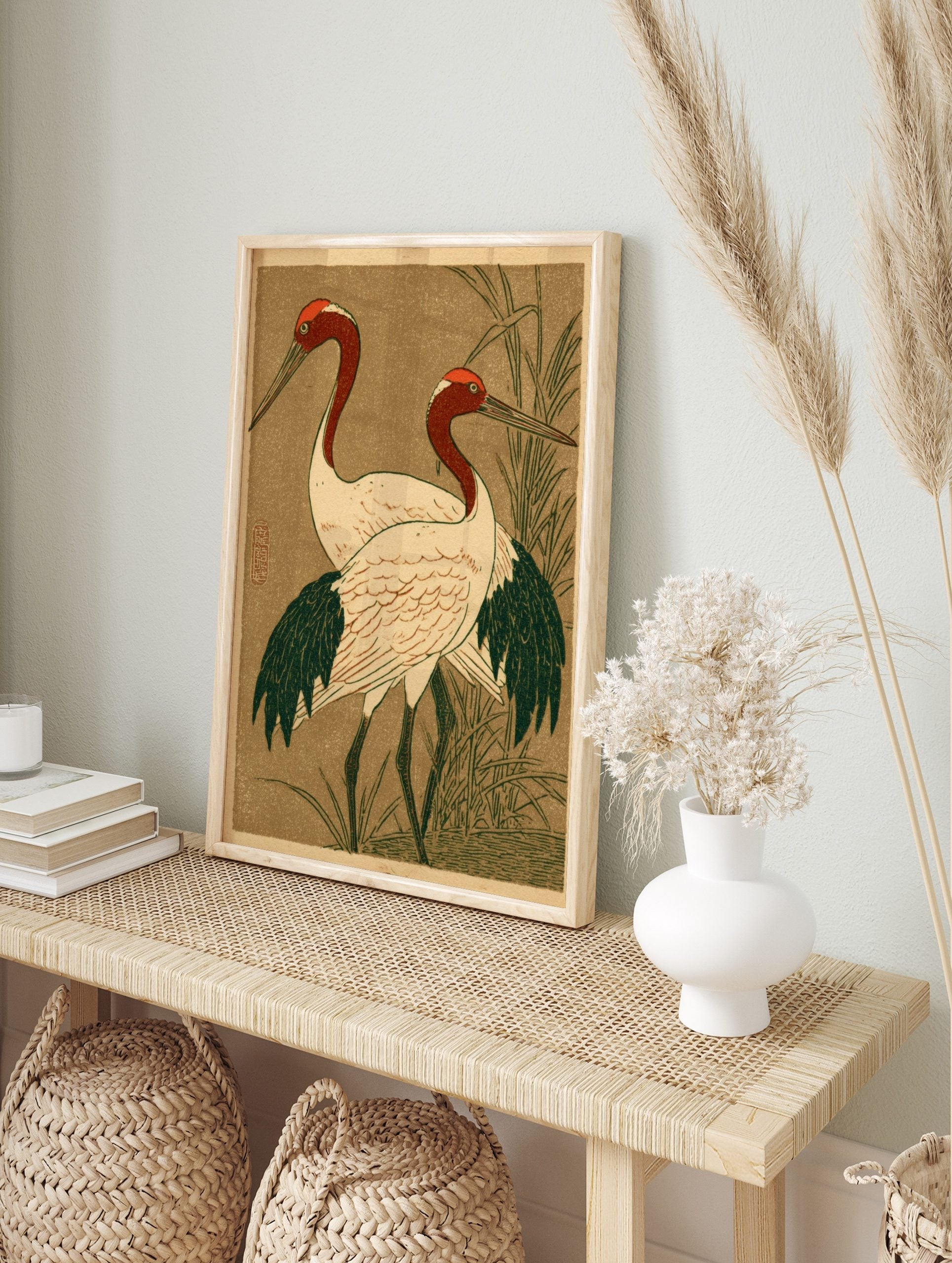 Japanese illustrative print of two red-headed cranes with white bodies and dark wings, in an alternate framed mockup