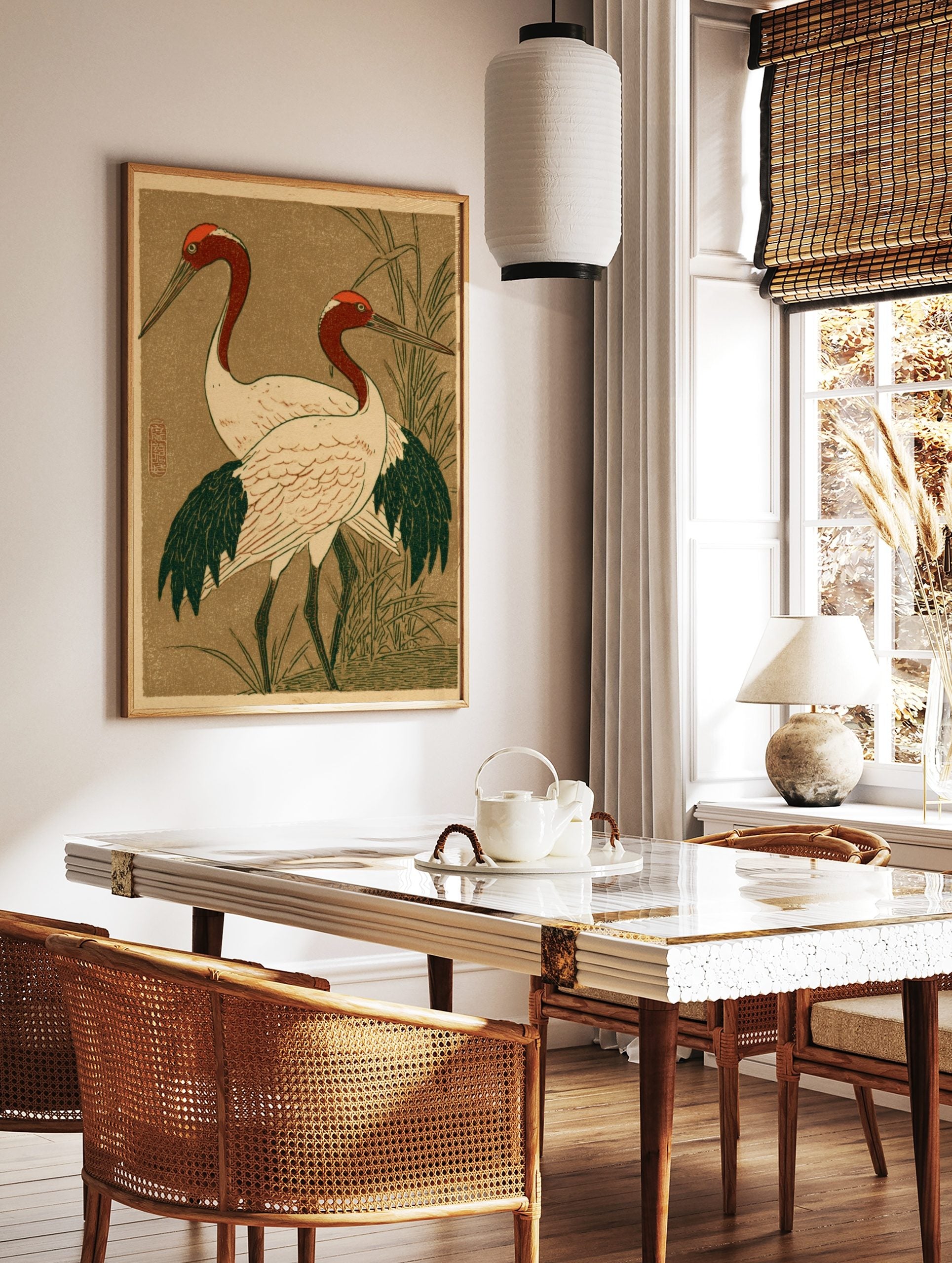 Japanese illustrative print of two red-headed cranes with white bodies and dark wings, standing in, in a styled room mockup