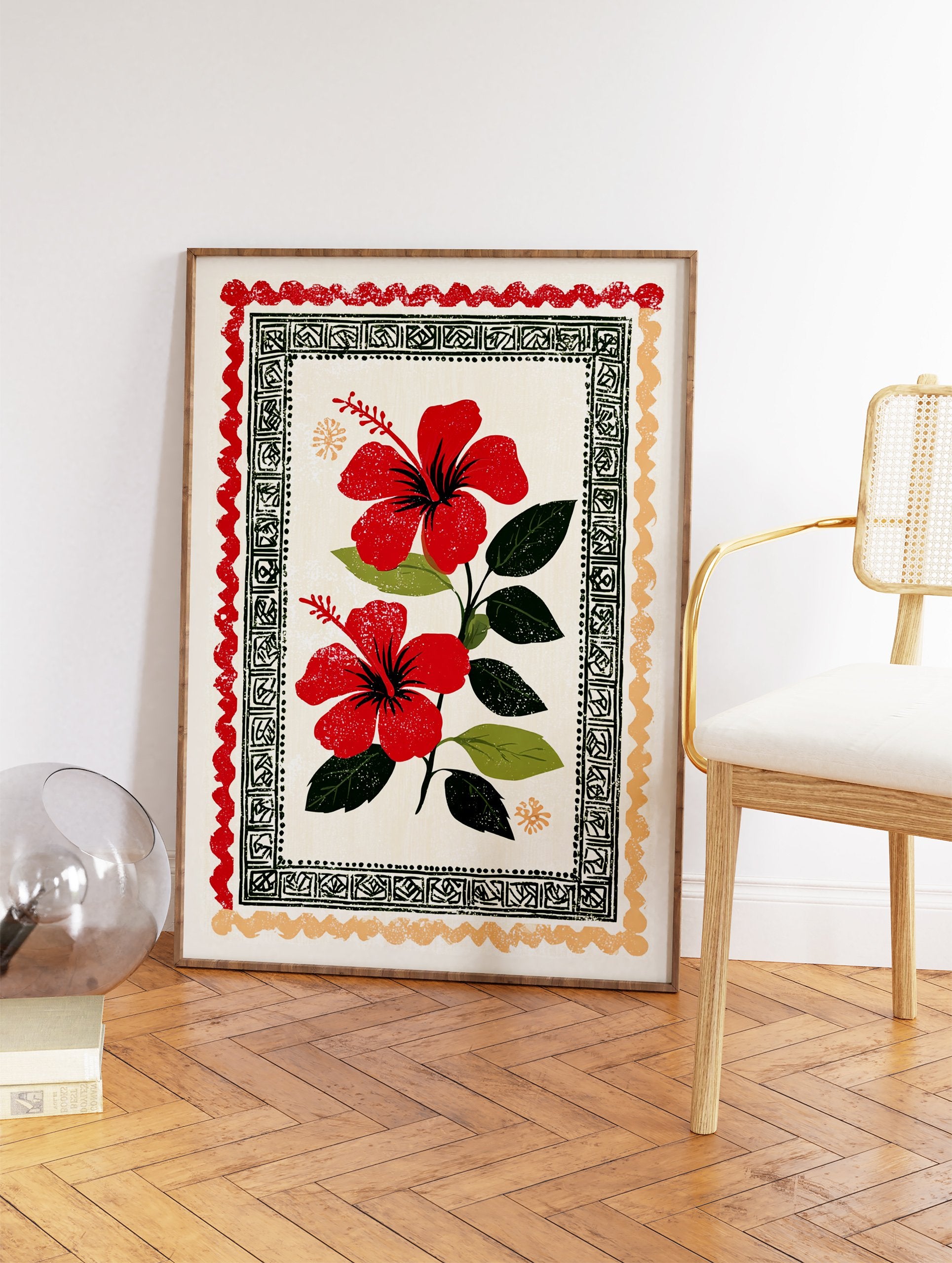 Red hibiscus wall art print with two vibrant flowers, green leaves, and decorative folk art borders on a cream background. - Image 2