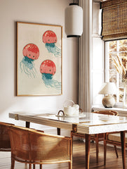 Illustrative red jellyfish wall art print with blue tentacles on a neutral background, in a styled room mockup