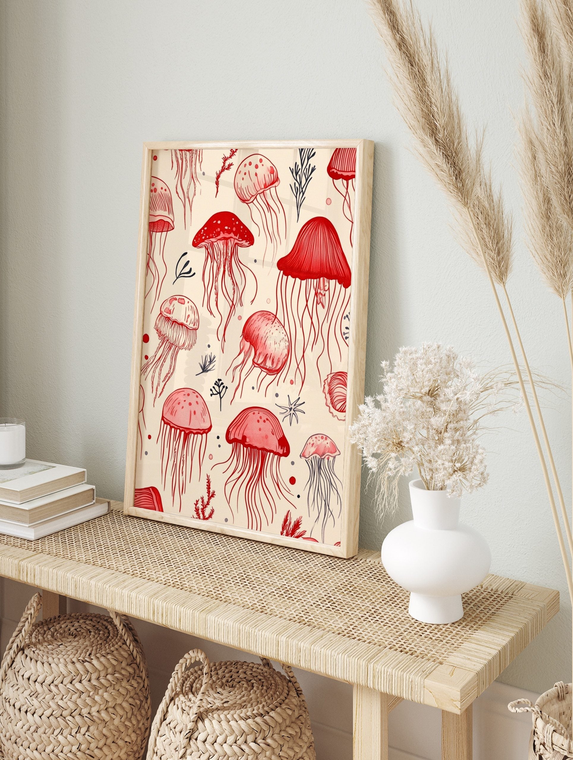 Illustrative art print featuring red jellyfish and dark marine plants on a light background, in an alternate framed mockup