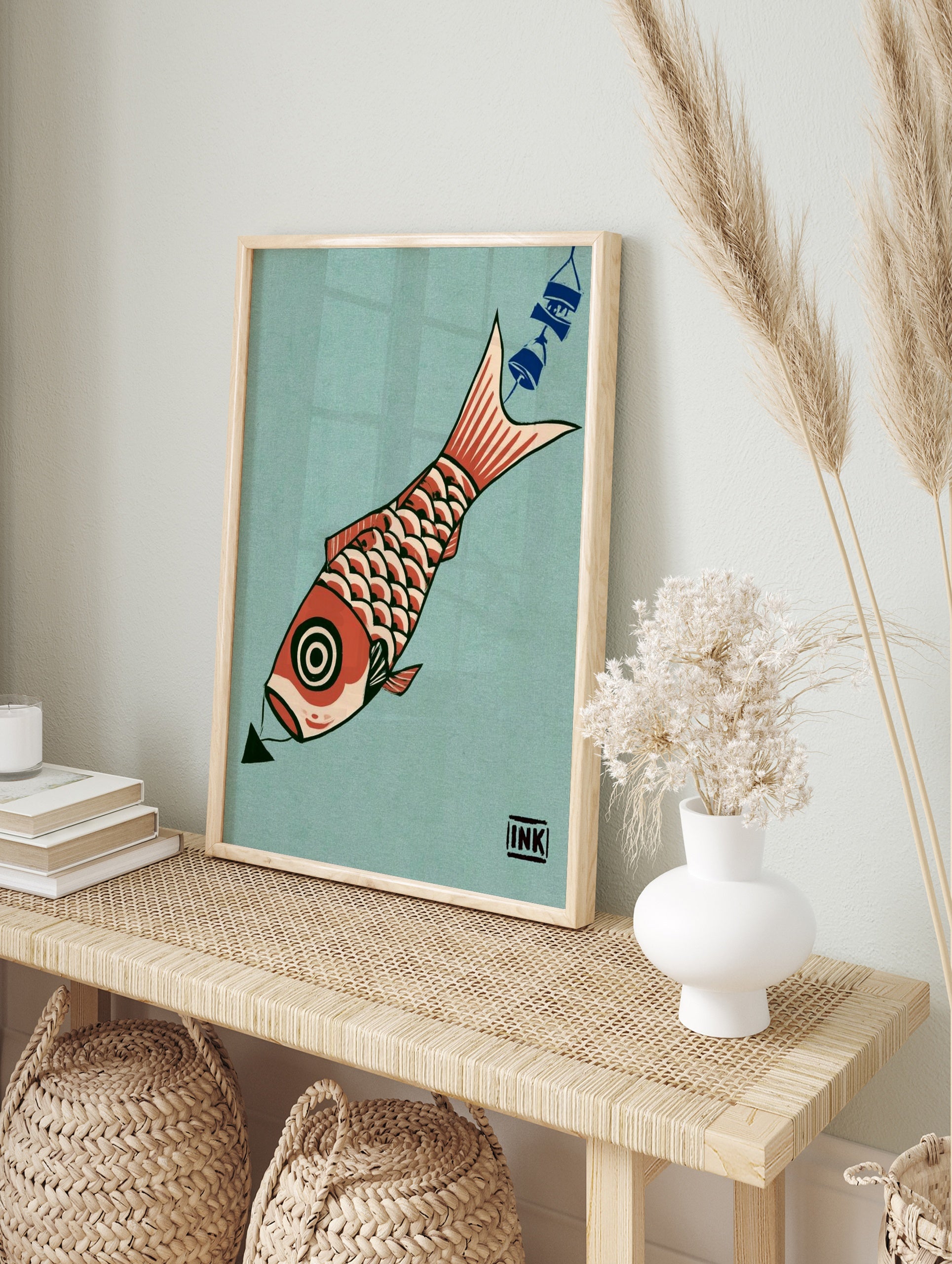 Graphic illustration of a red koi fish with a circular eye and scale pattern on a teal, in an alternate framed mockup
