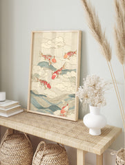 Red and white koi fish leaping over blue waves and white clouds on a beige textured, in an alternate framed mockup