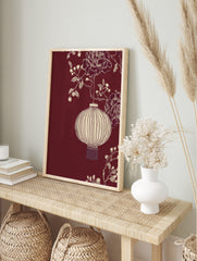 Illustrative off-white Chinese lantern with peonies and berries on a deep red background, in an alternate framed mockup