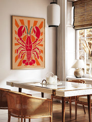 Red lobster illustration with large claws and teal antennae, centered on an orange sunburst, in a styled room mockup