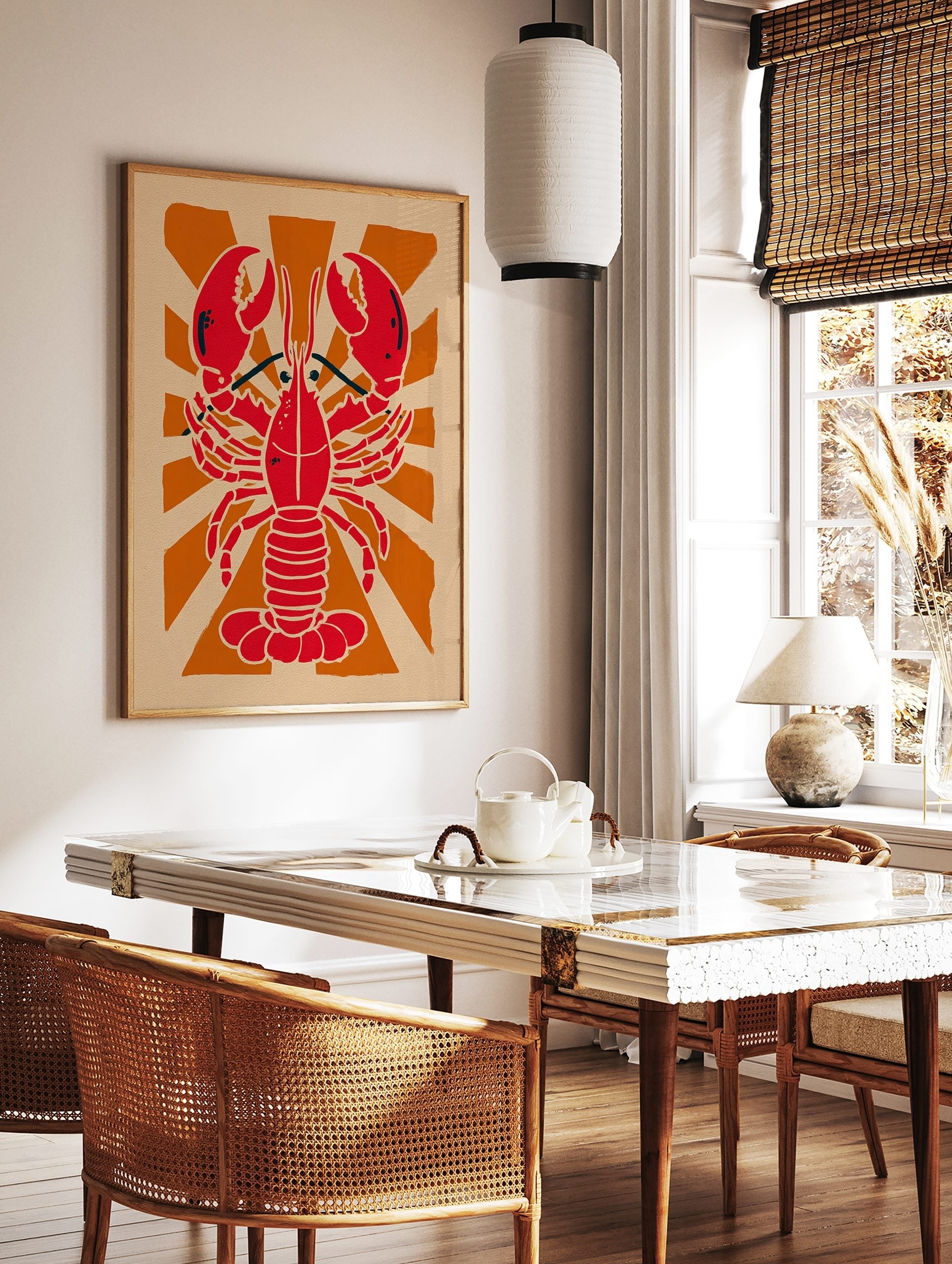 Red lobster illustration against an orange sunburst background on beige paper in a graphic style, in a styled room mockup